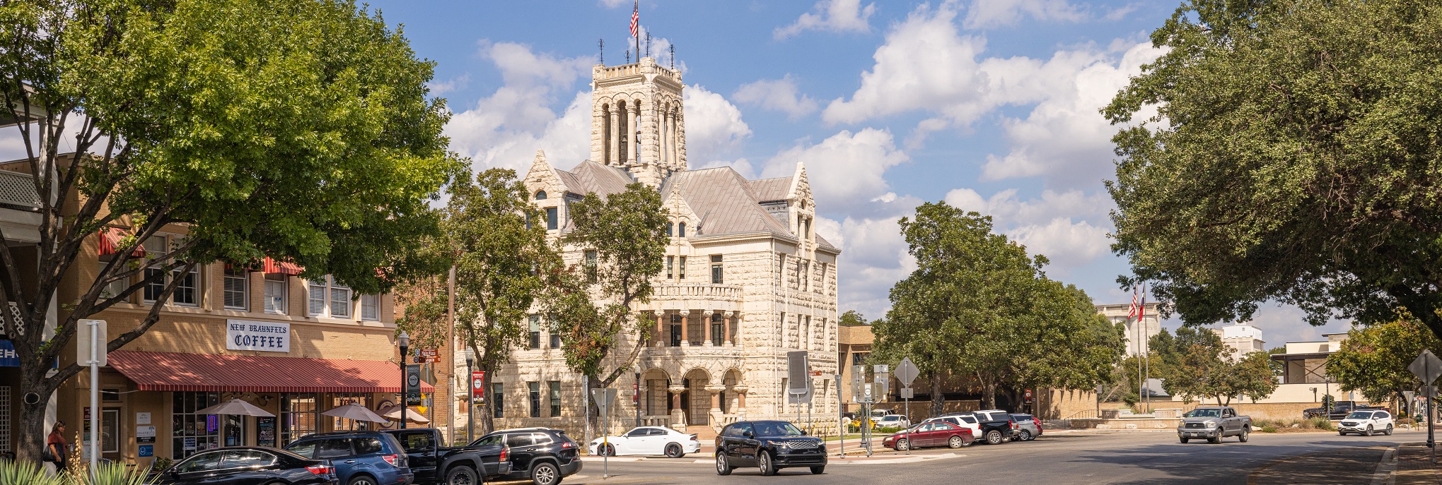 A street with cars and buildings on the side.