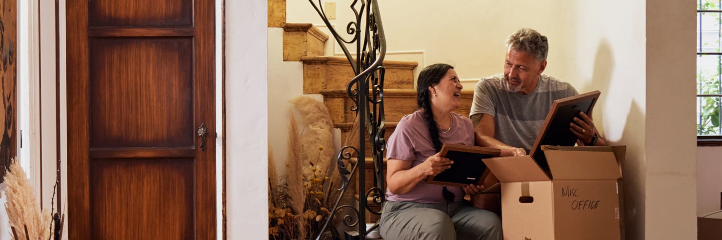 Couple in home with moving box