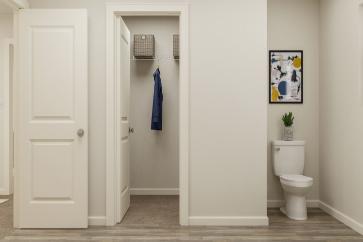 A bathroom with a toilet and a shower unit.
