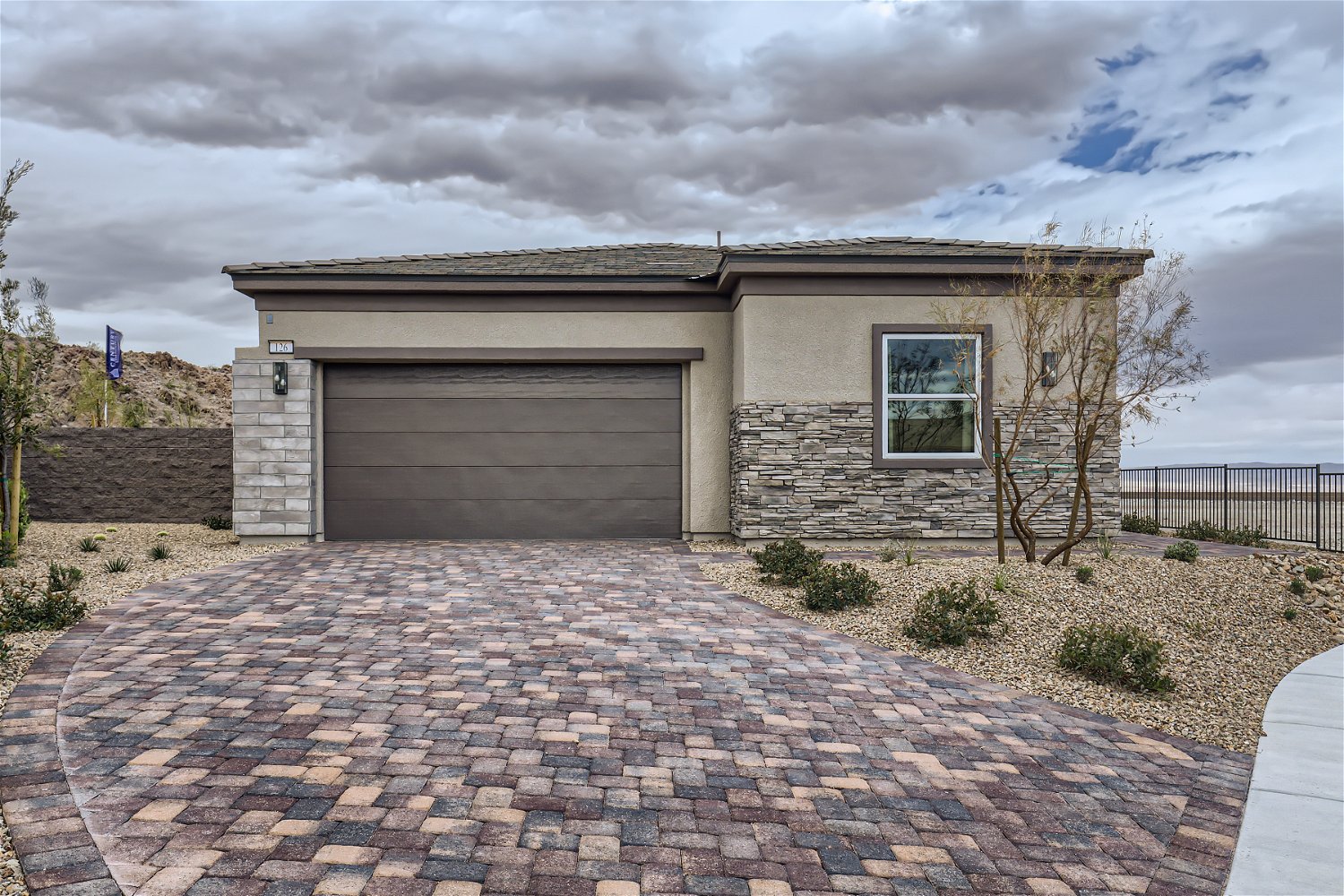 A house with a brick driveway.