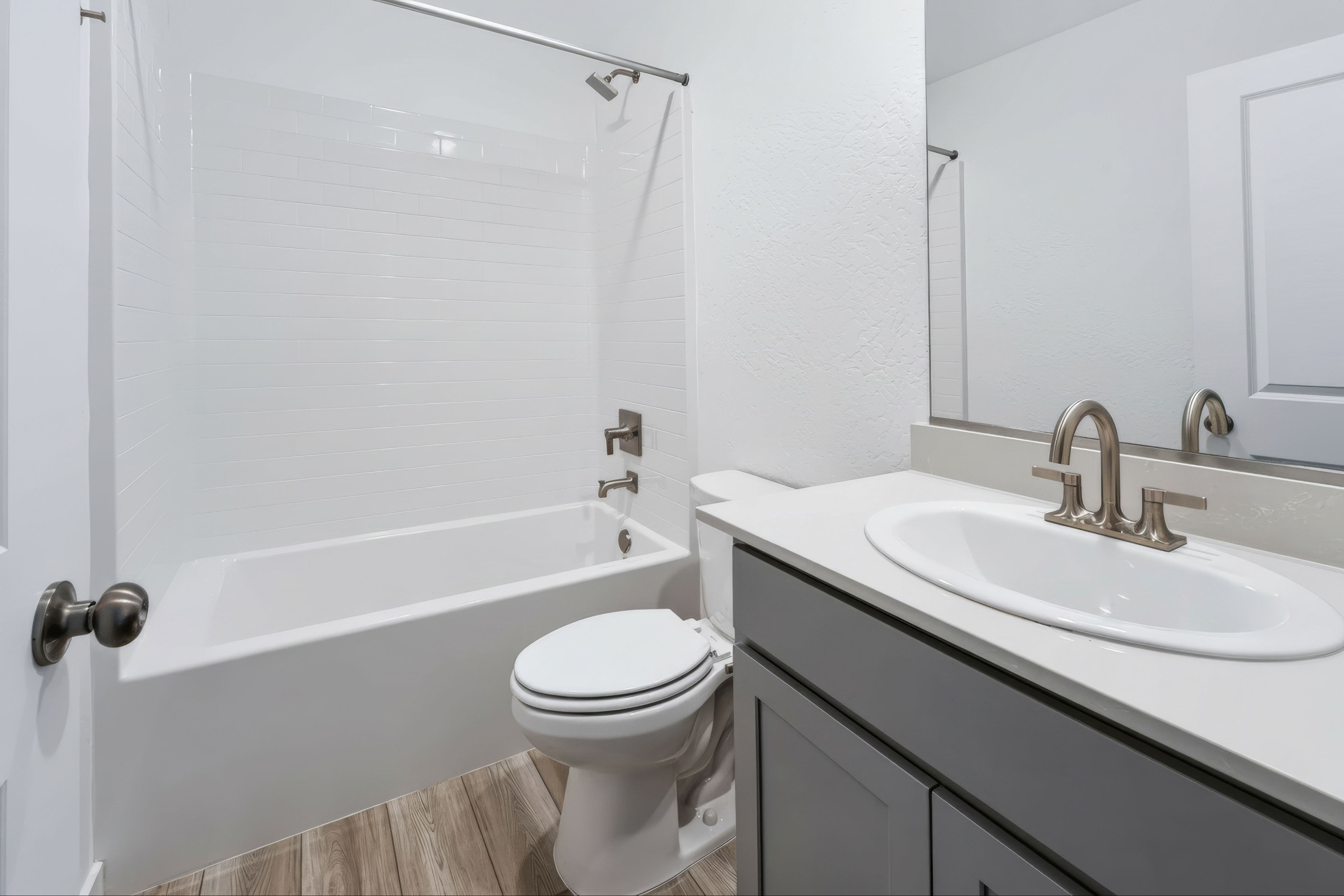 A bathroom with a sink toilet and bathtub.