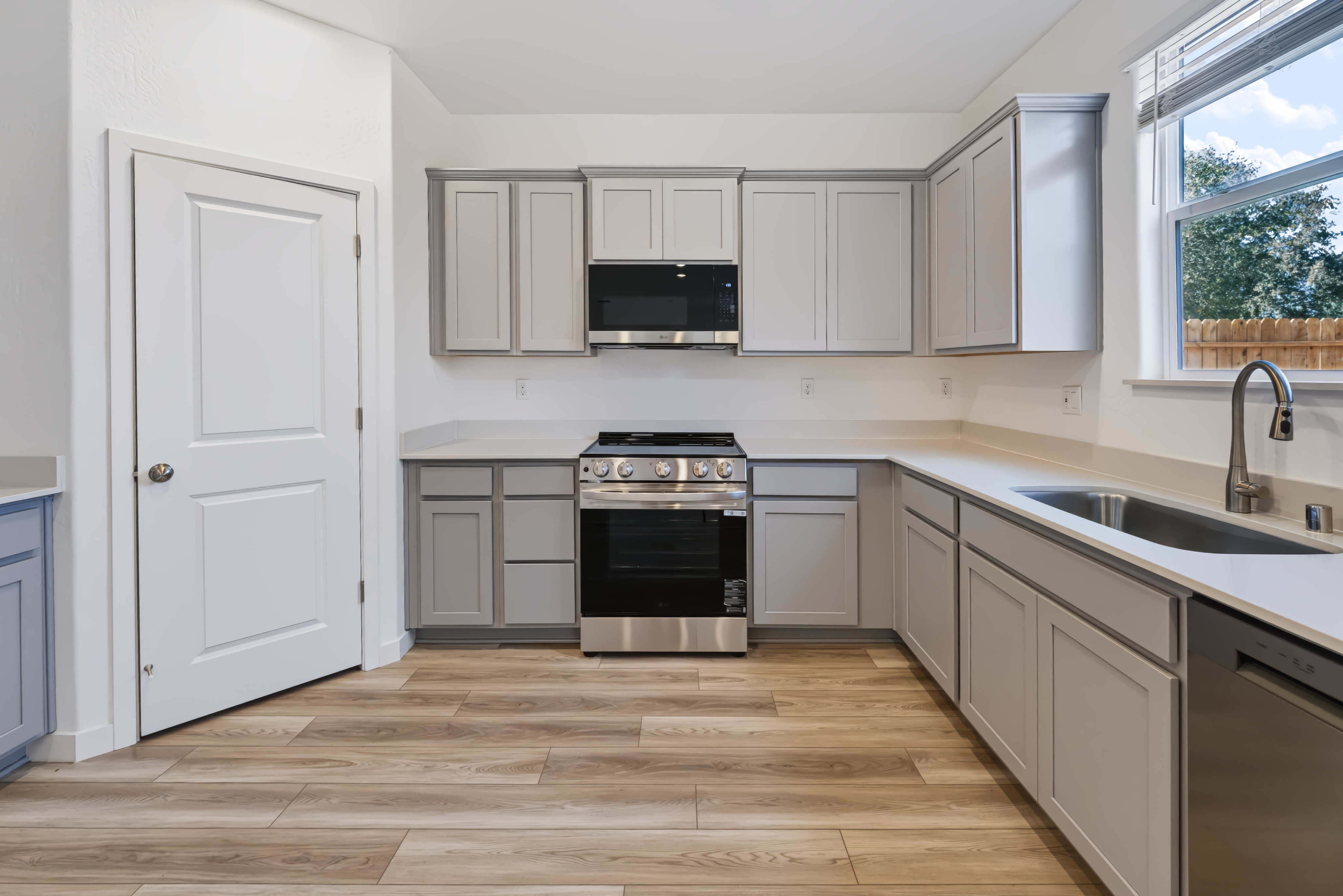 A kitchen with white cabinets.