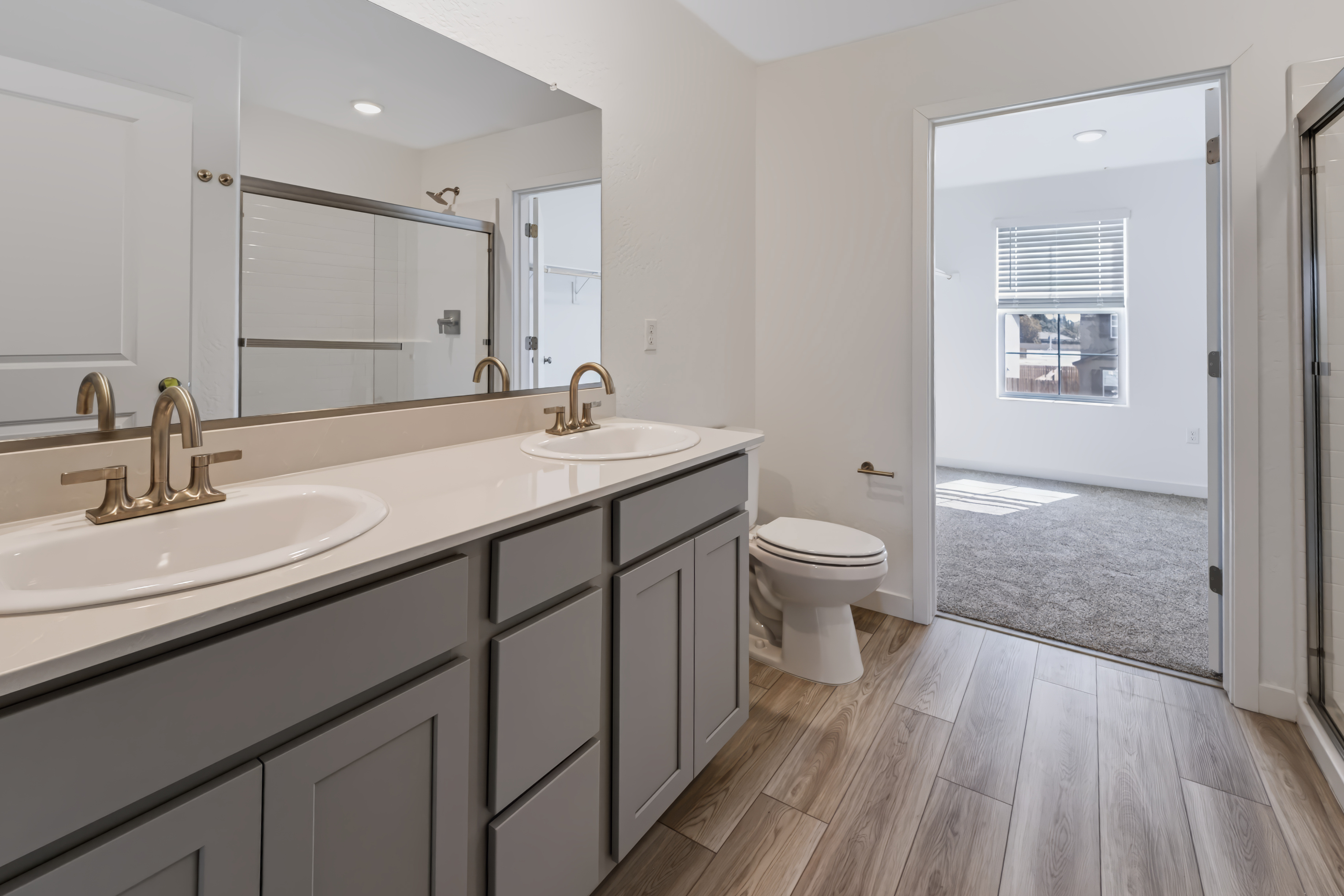 A bathroom with a toilet sink and mirror.