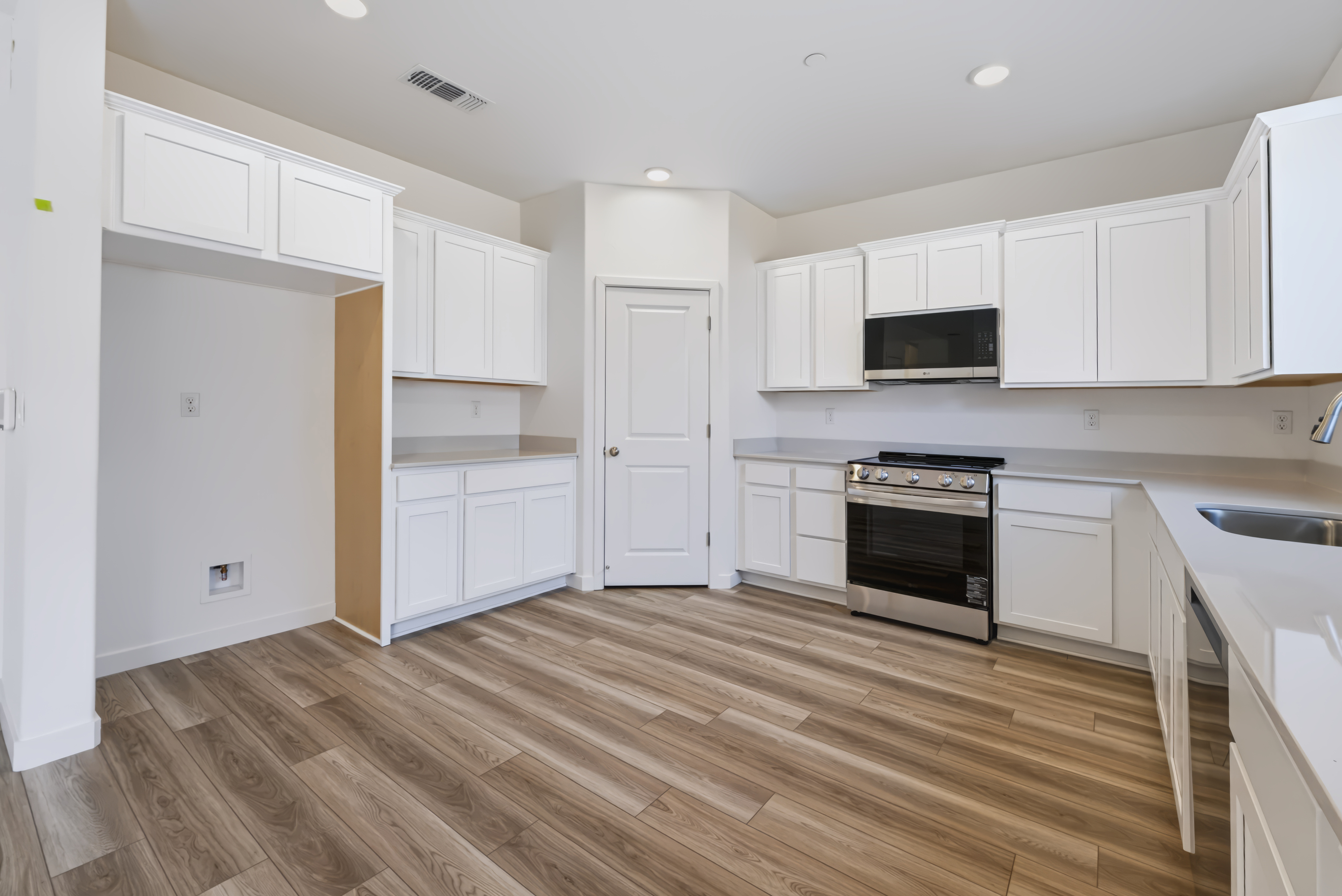 A kitchen with white cabinets.