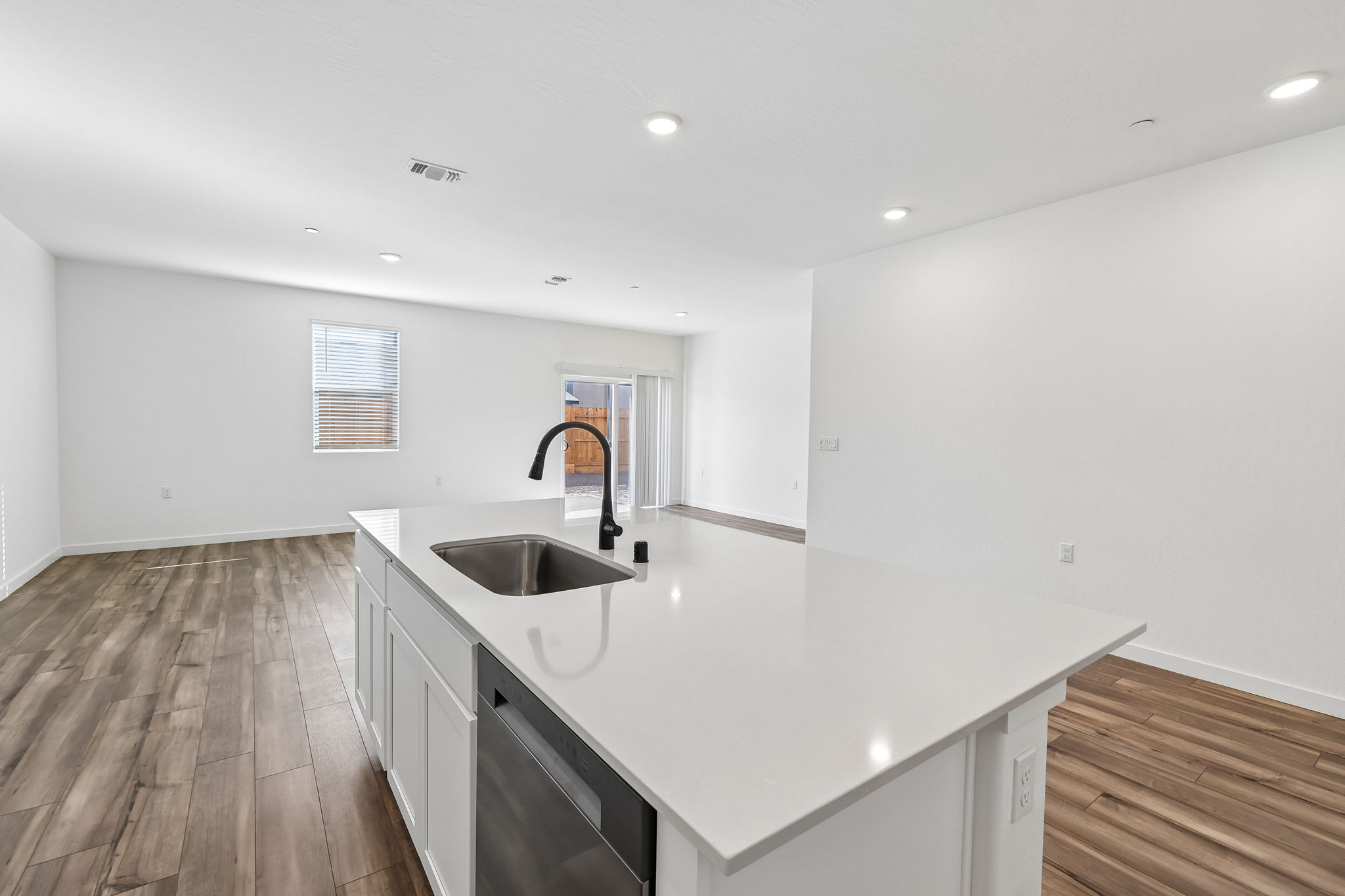 A kitchen with a sink and a bench.