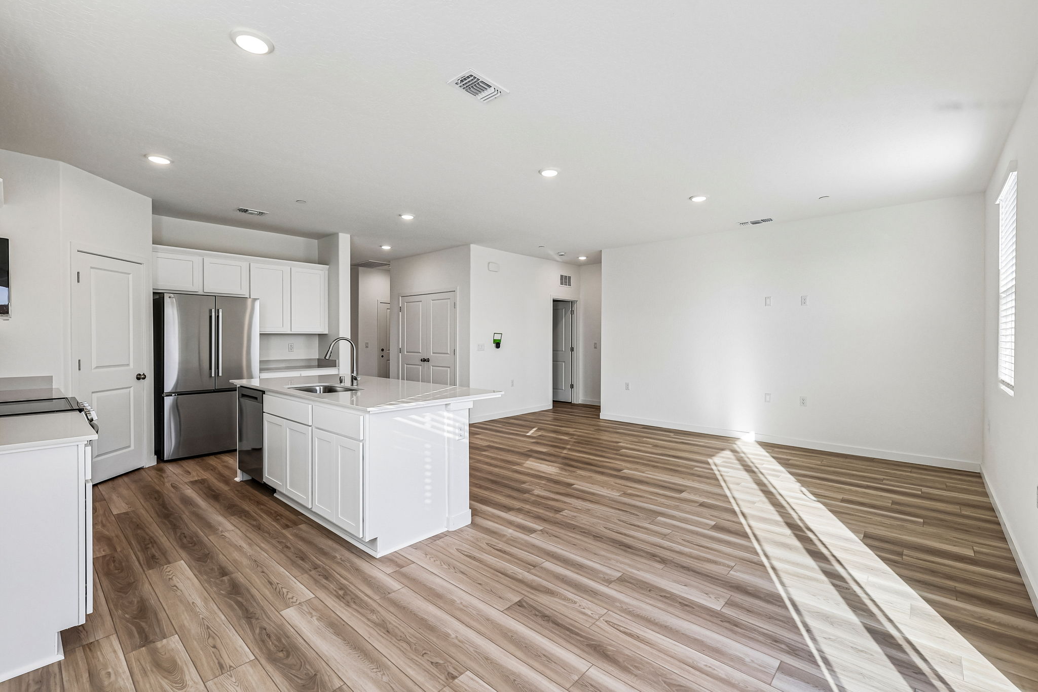A kitchen with white cabinets.