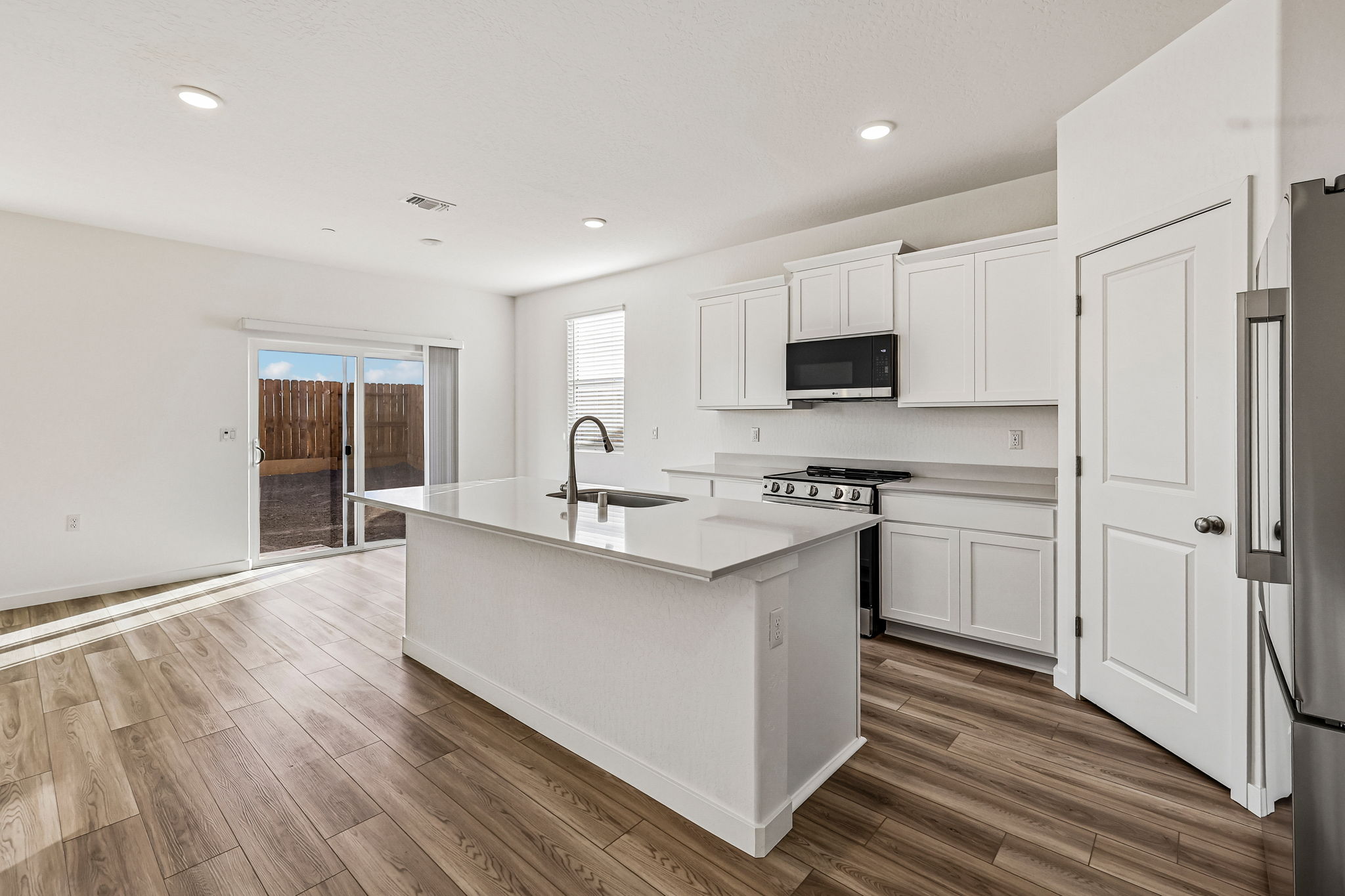 A kitchen with white cabinets.