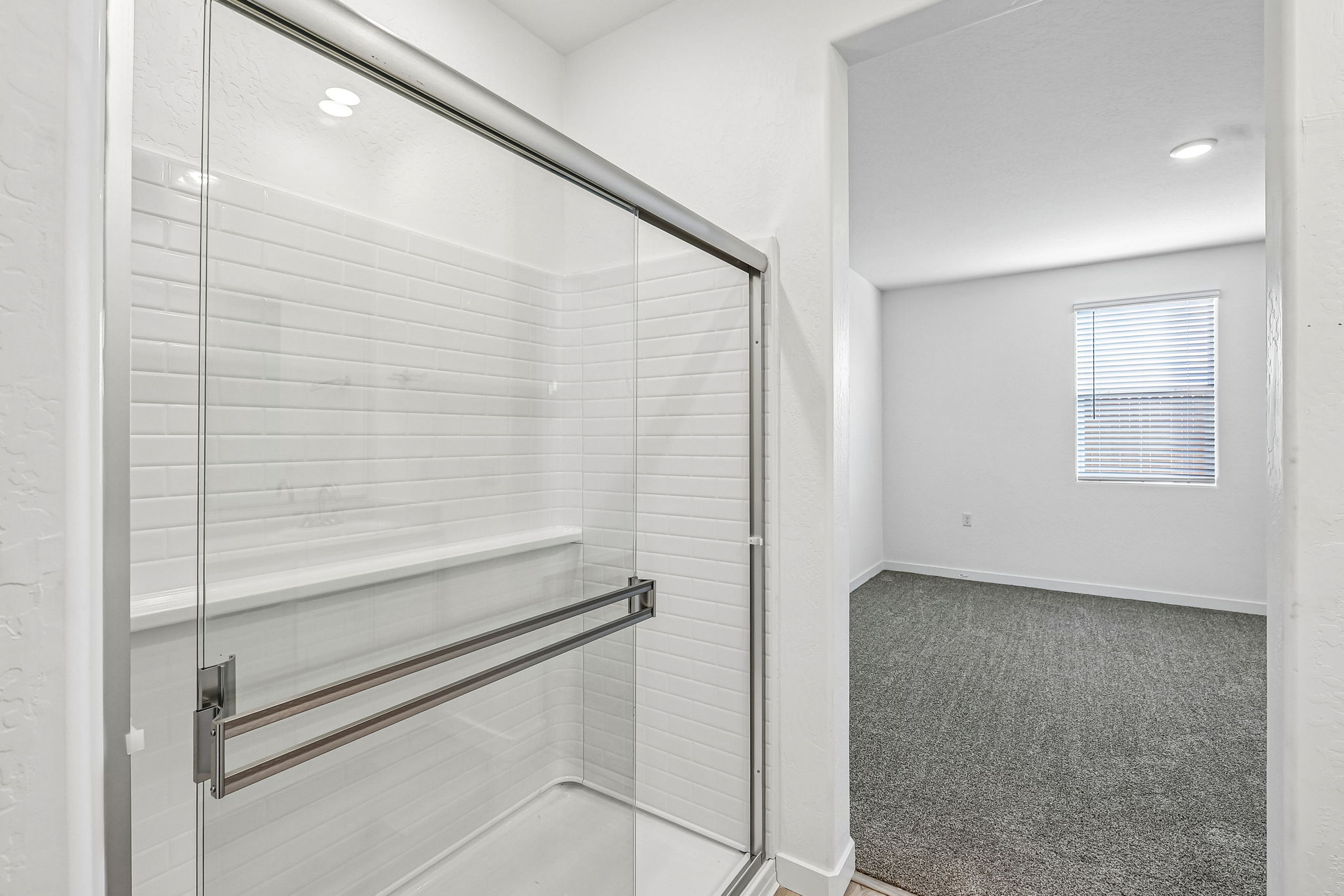 A shower with a glass door.