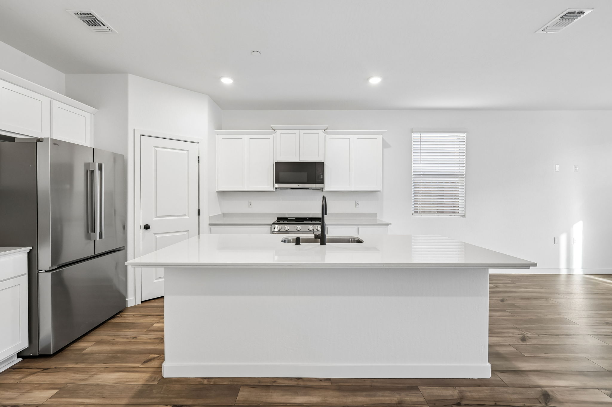 A kitchen with white cabinets.