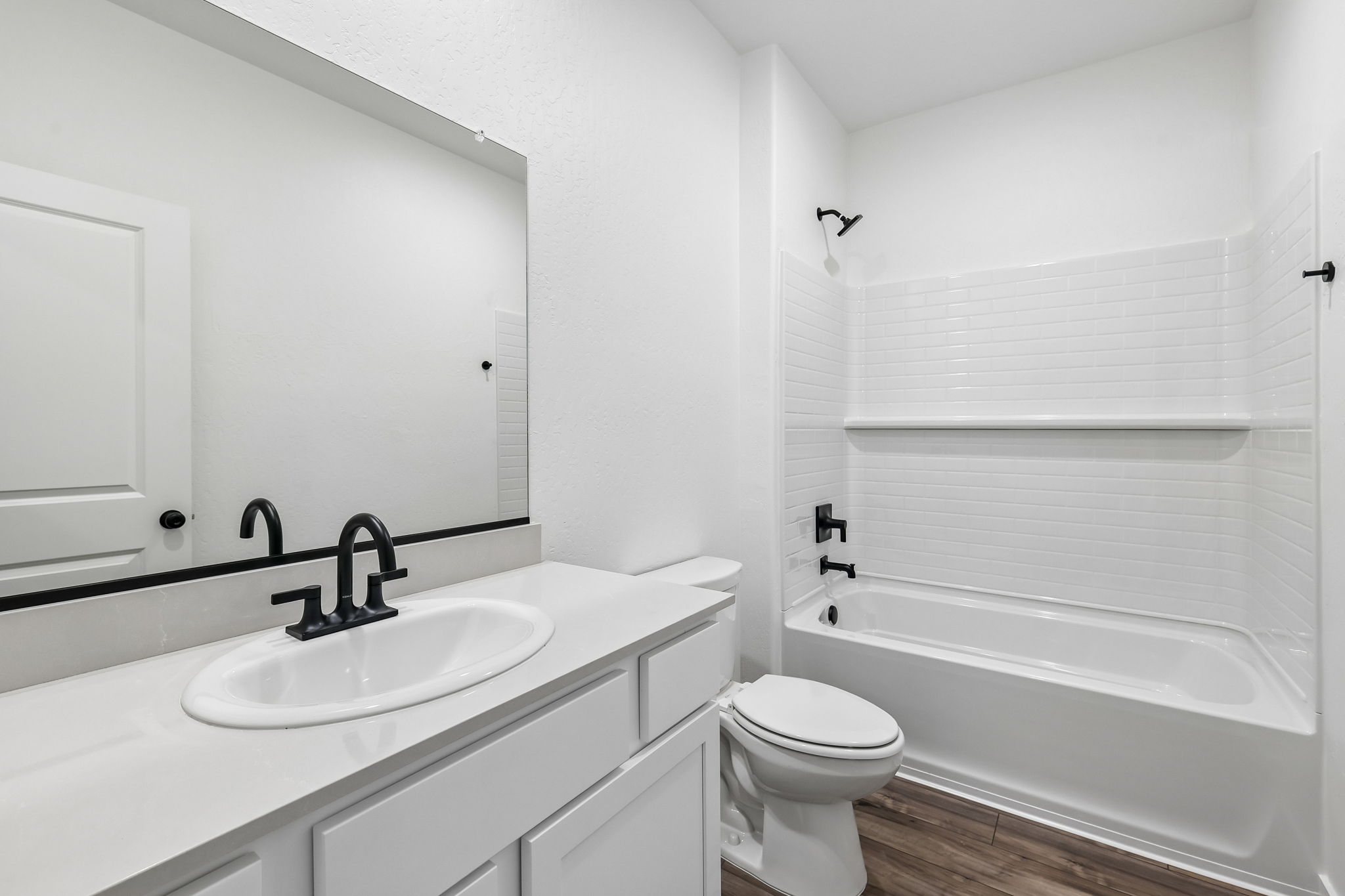 A bathroom with a sink toilet and bathtub.