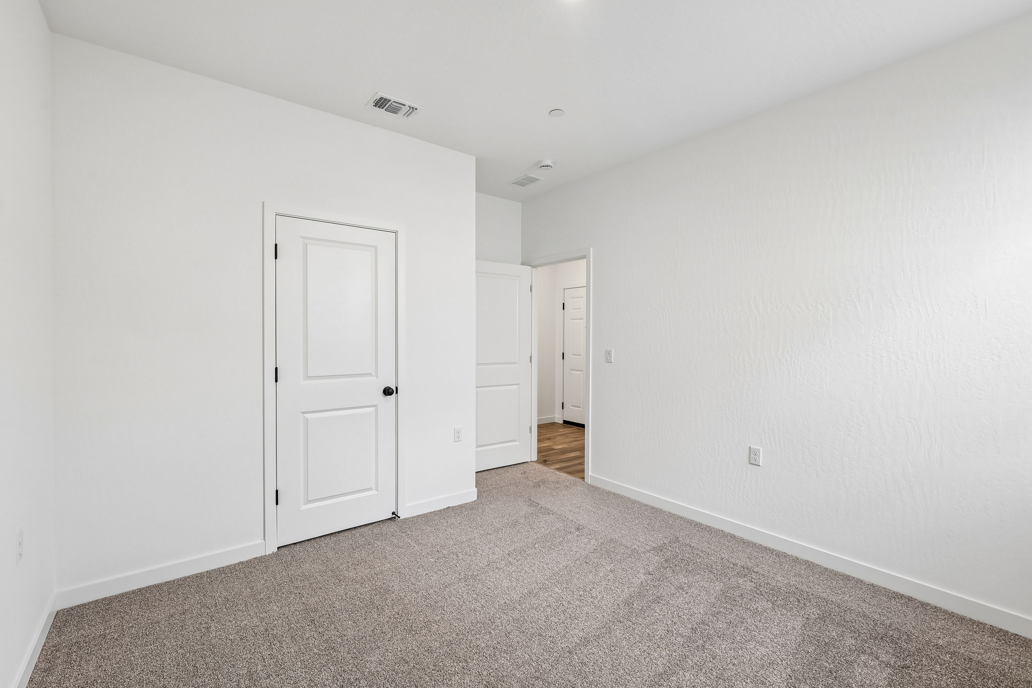 A hallway with white doors.