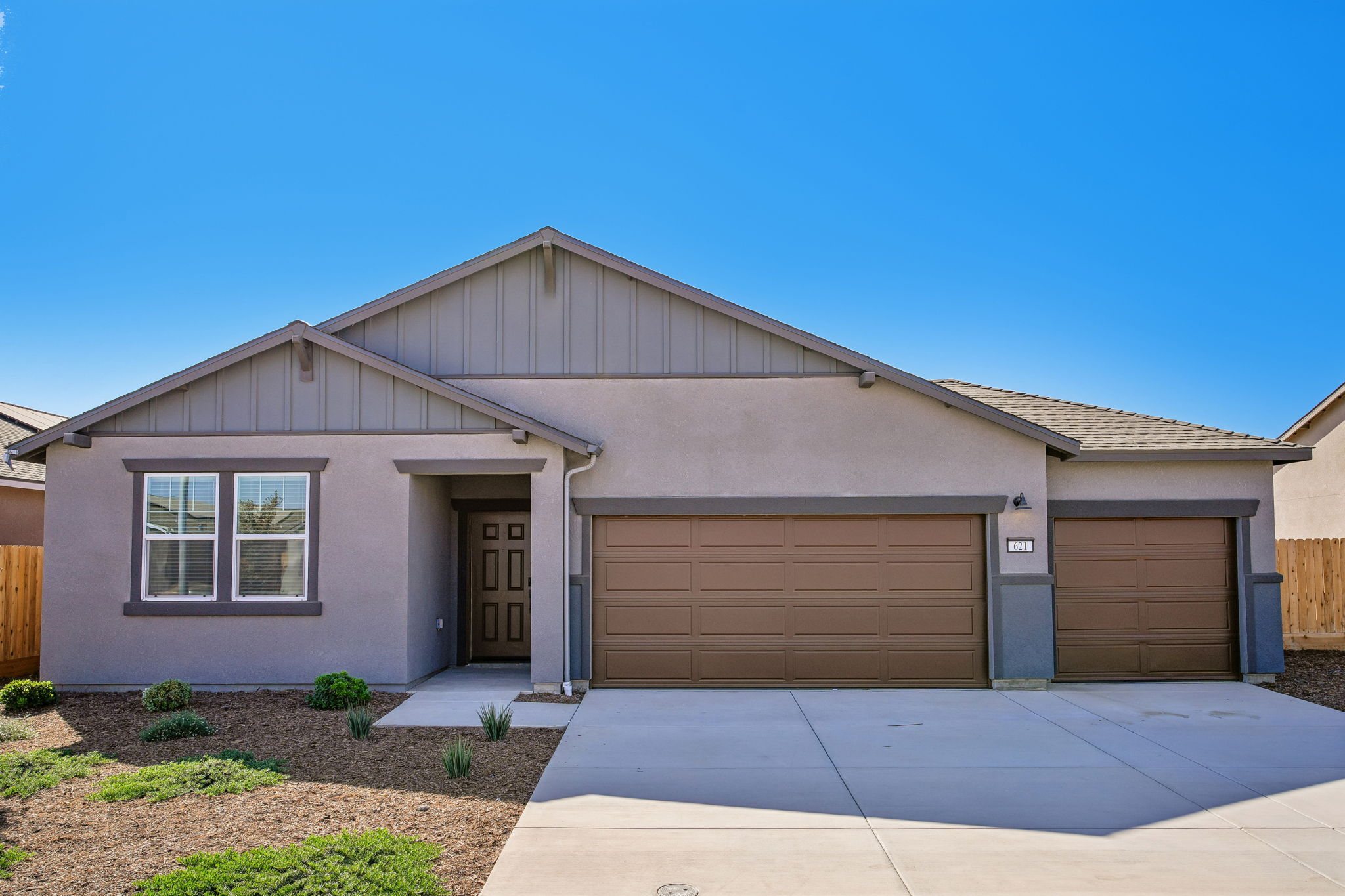 A house with garages and a driveway.