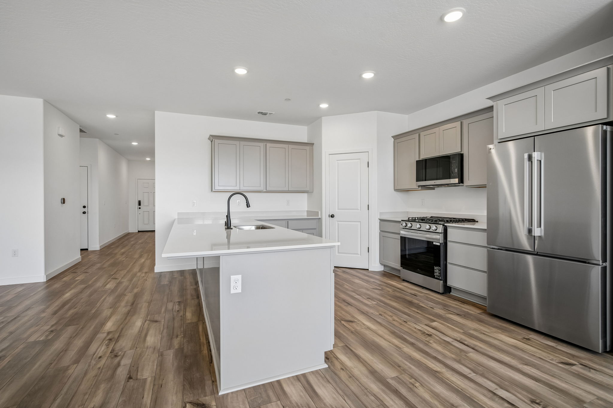 A kitchen with white cabinets.