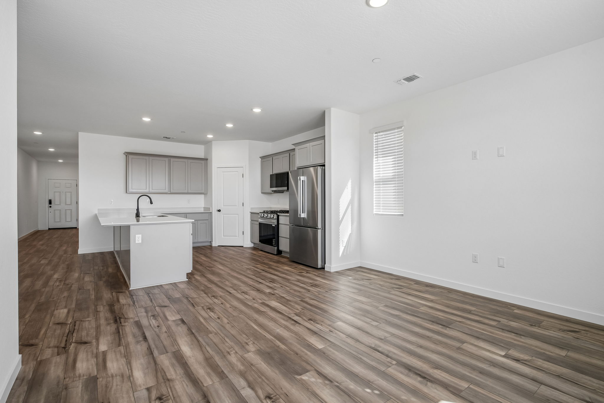 A kitchen with white cabinets.