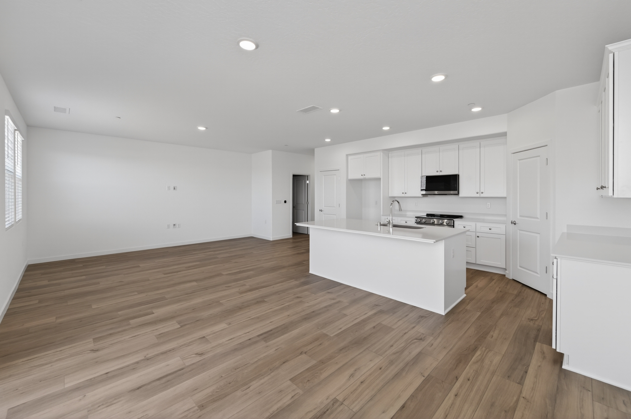 A kitchen with white cabinets.