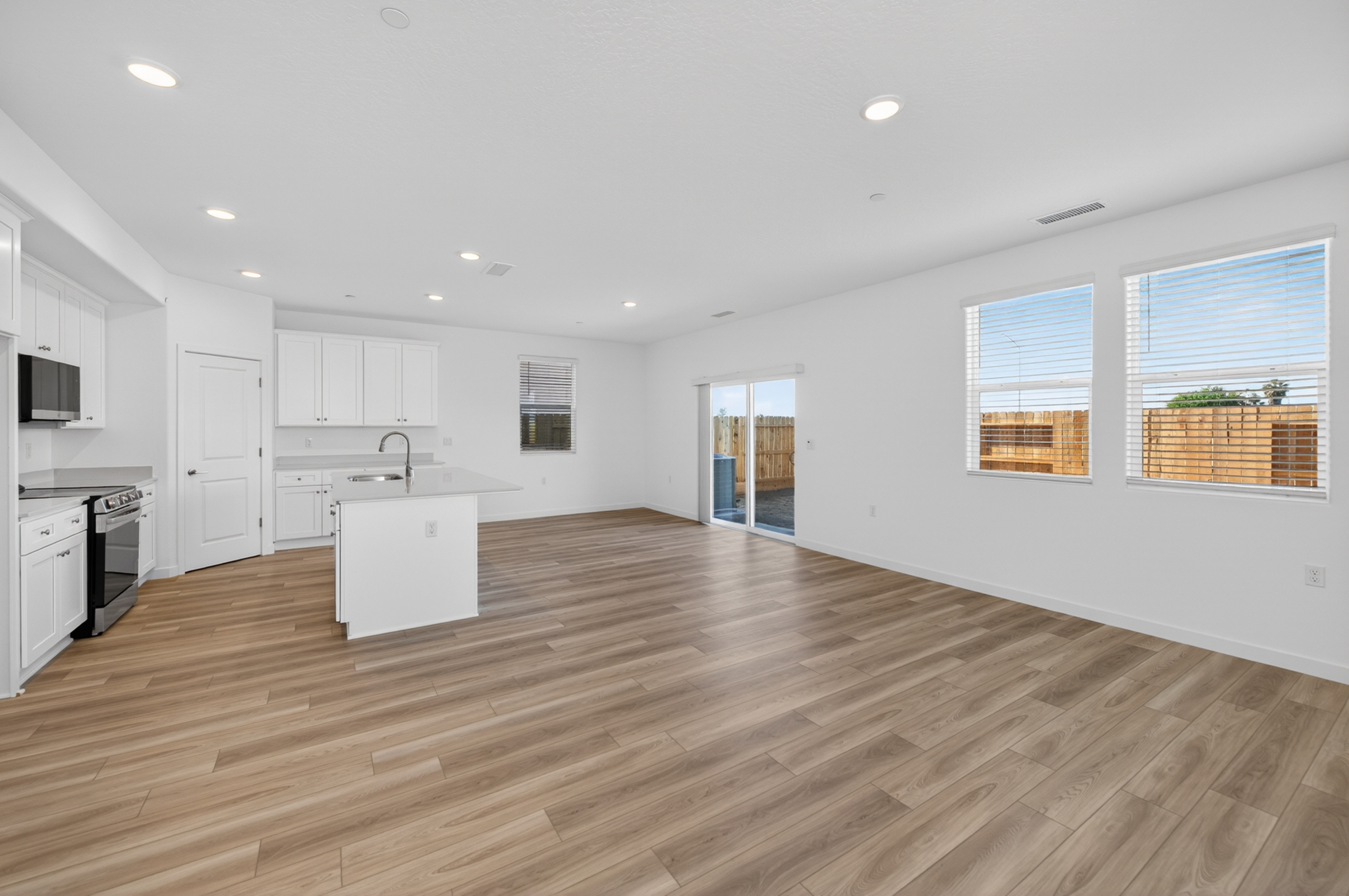 A large kitchen with white cabinets.