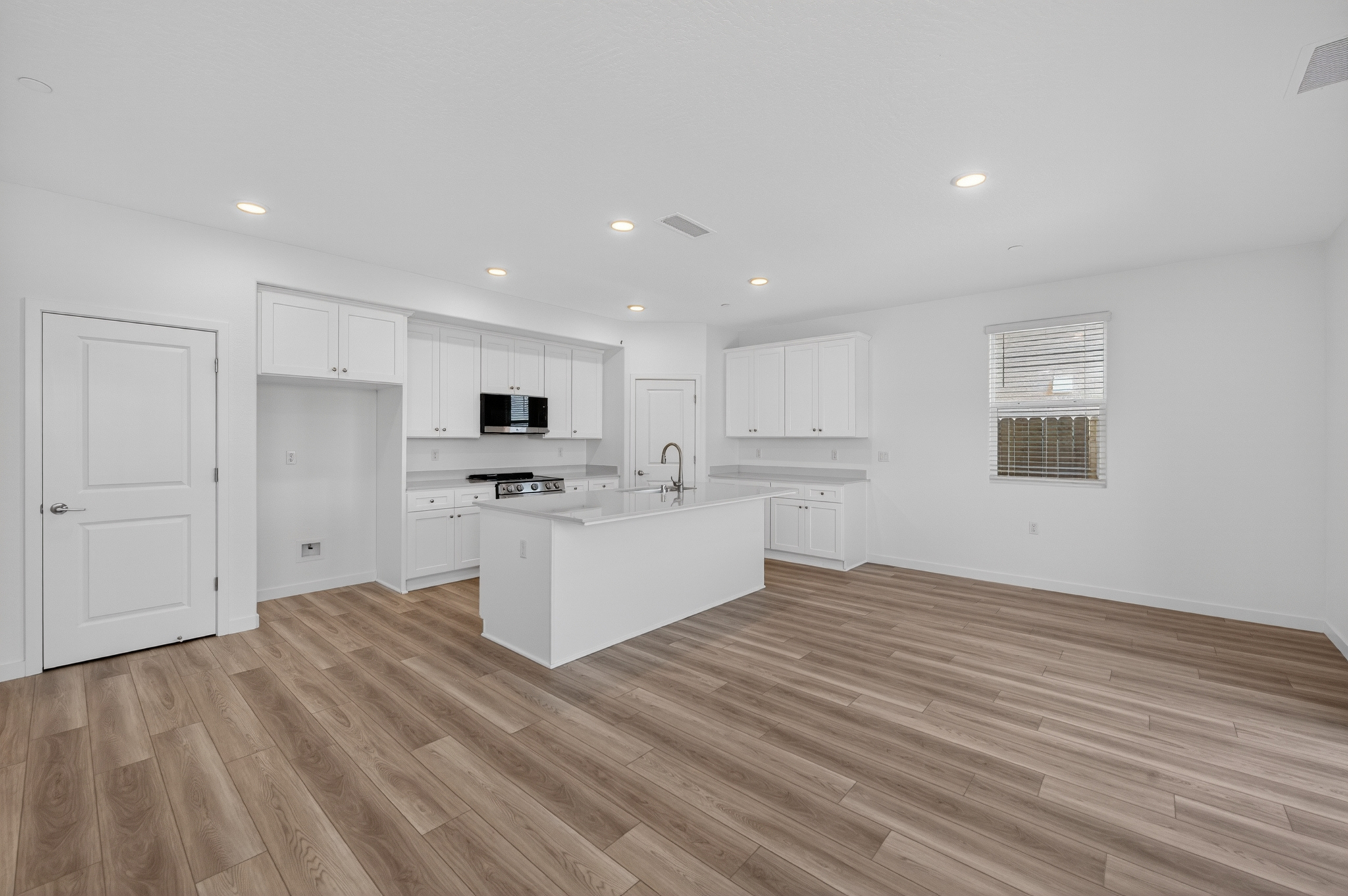 A kitchen with white cabinets.