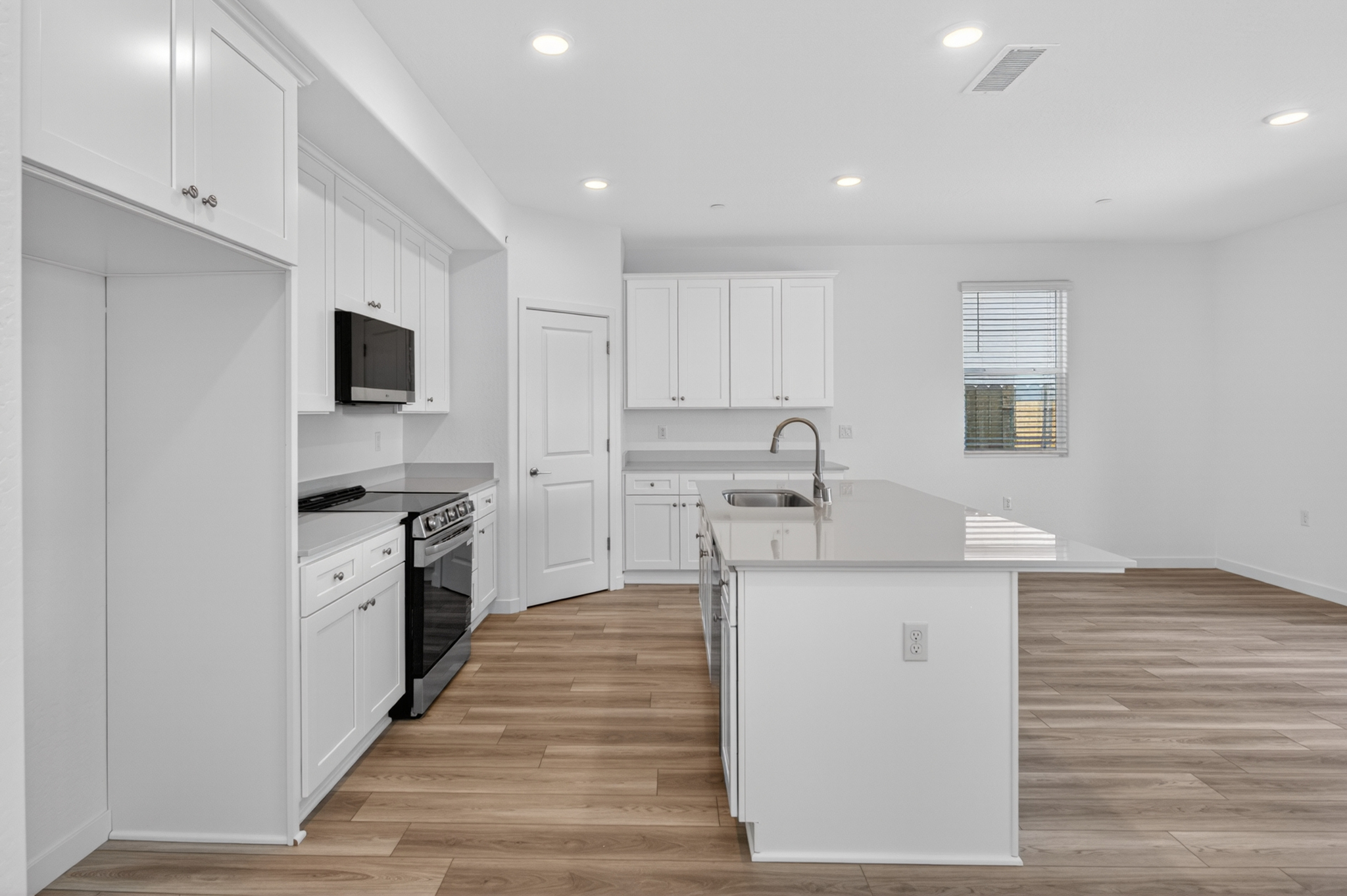 A kitchen with white cabinets.
