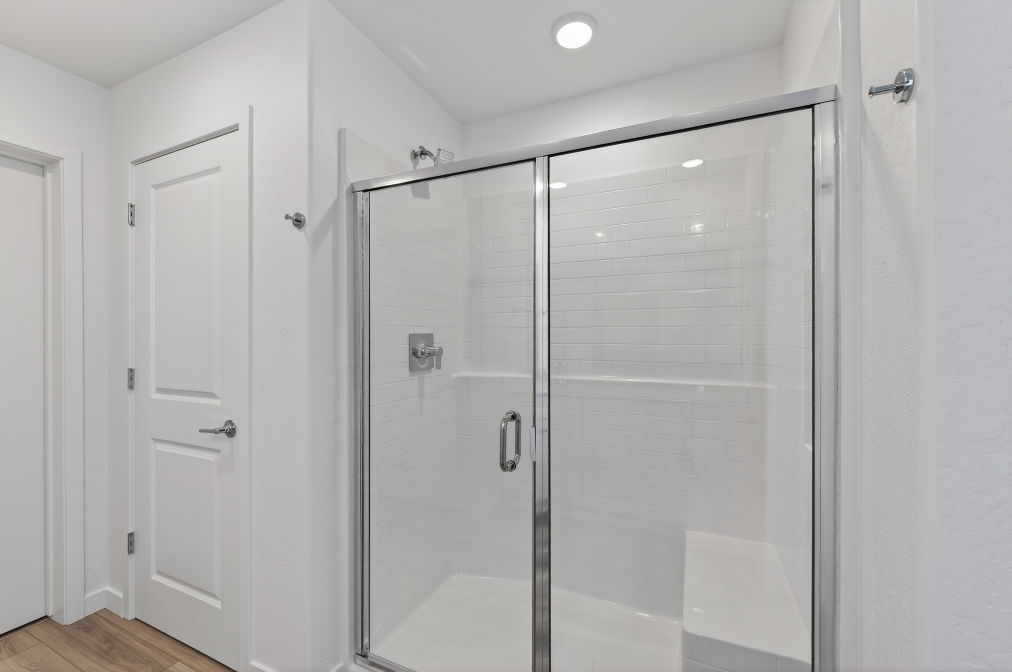 A shower with a glass door.