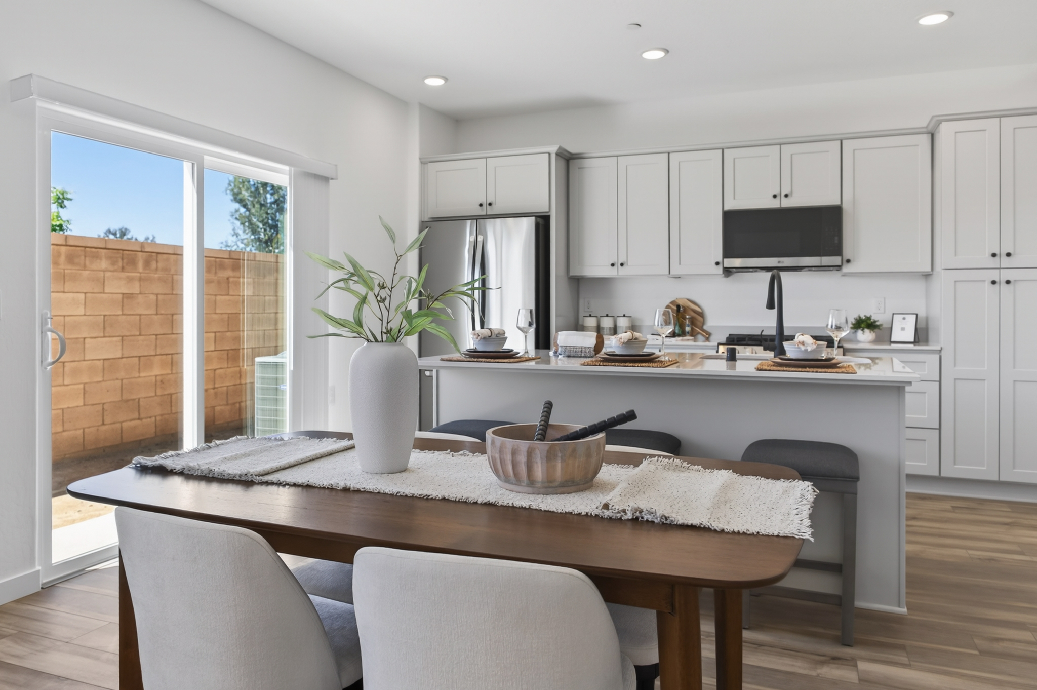 A kitchen with a table and chairs.