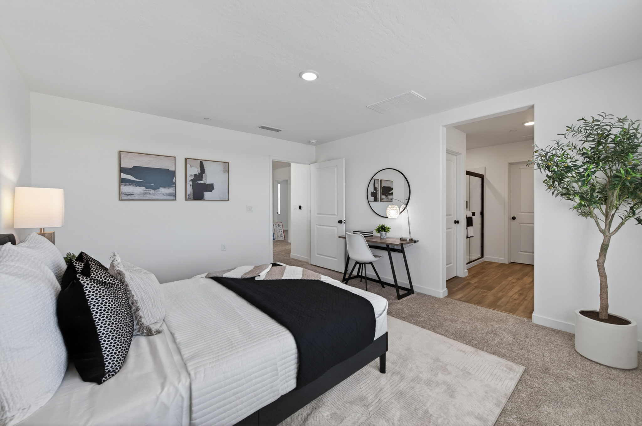 A bedroom with a bed and a table.