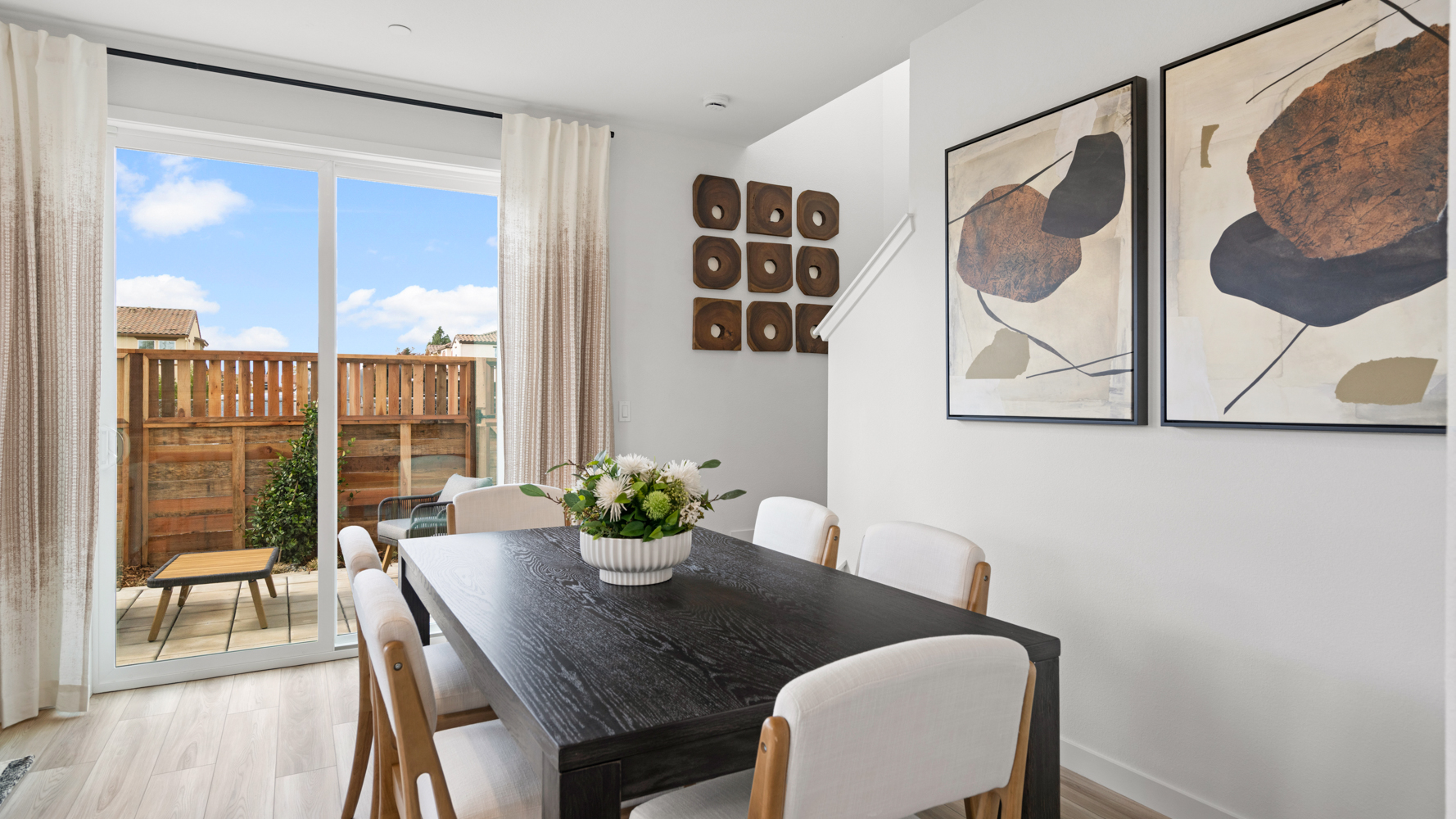 A dining room table with a plant on it.