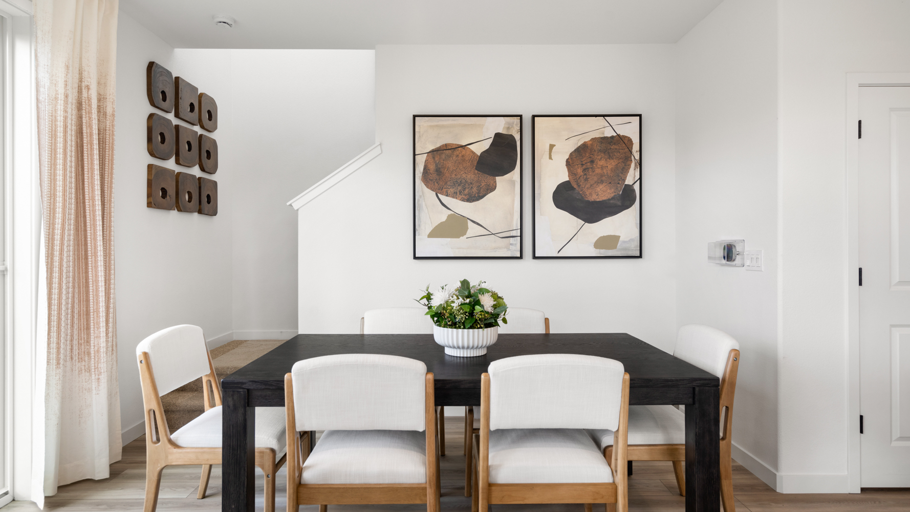 A dining table with chairs around it.