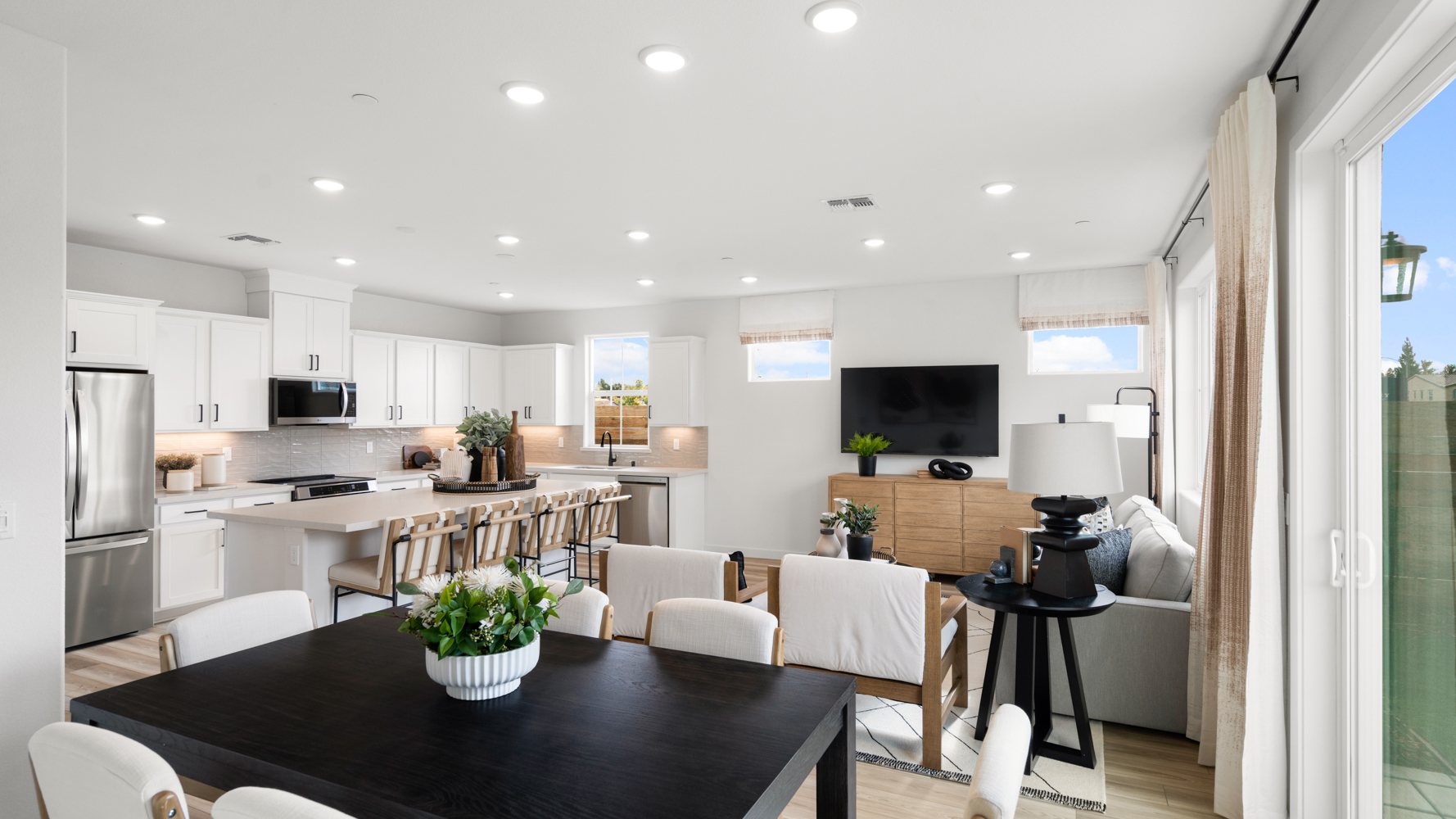 A large kitchen with a dining table.
