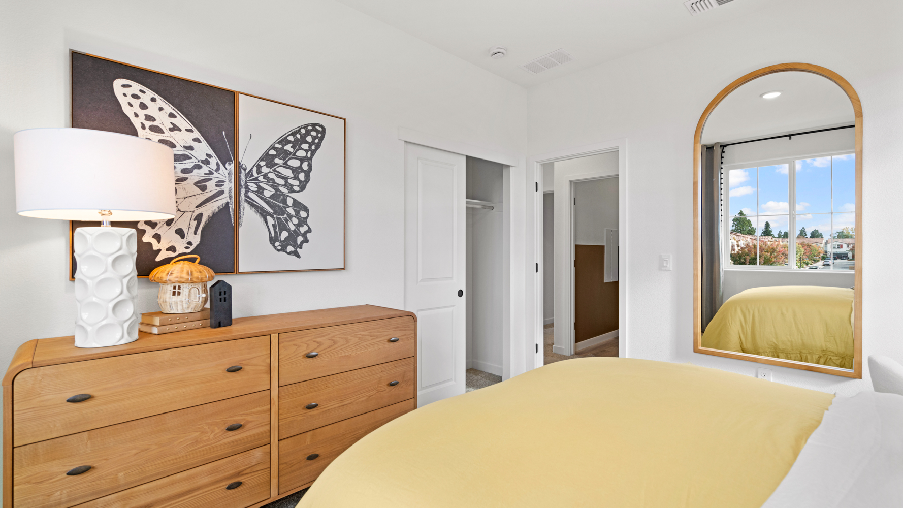 A bedroom with a bed and a lamp.