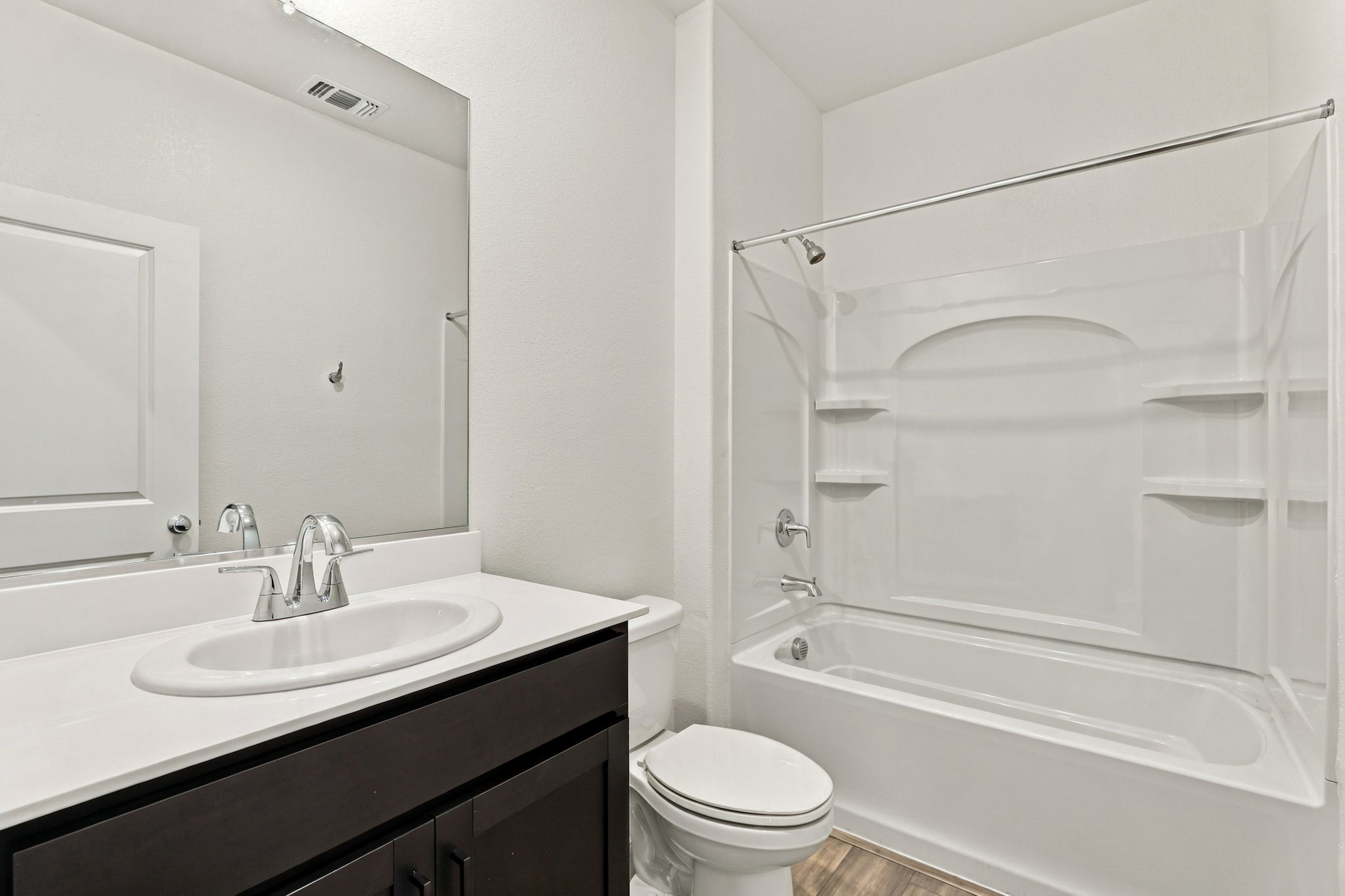 A bathroom with a tub sink and toilet.