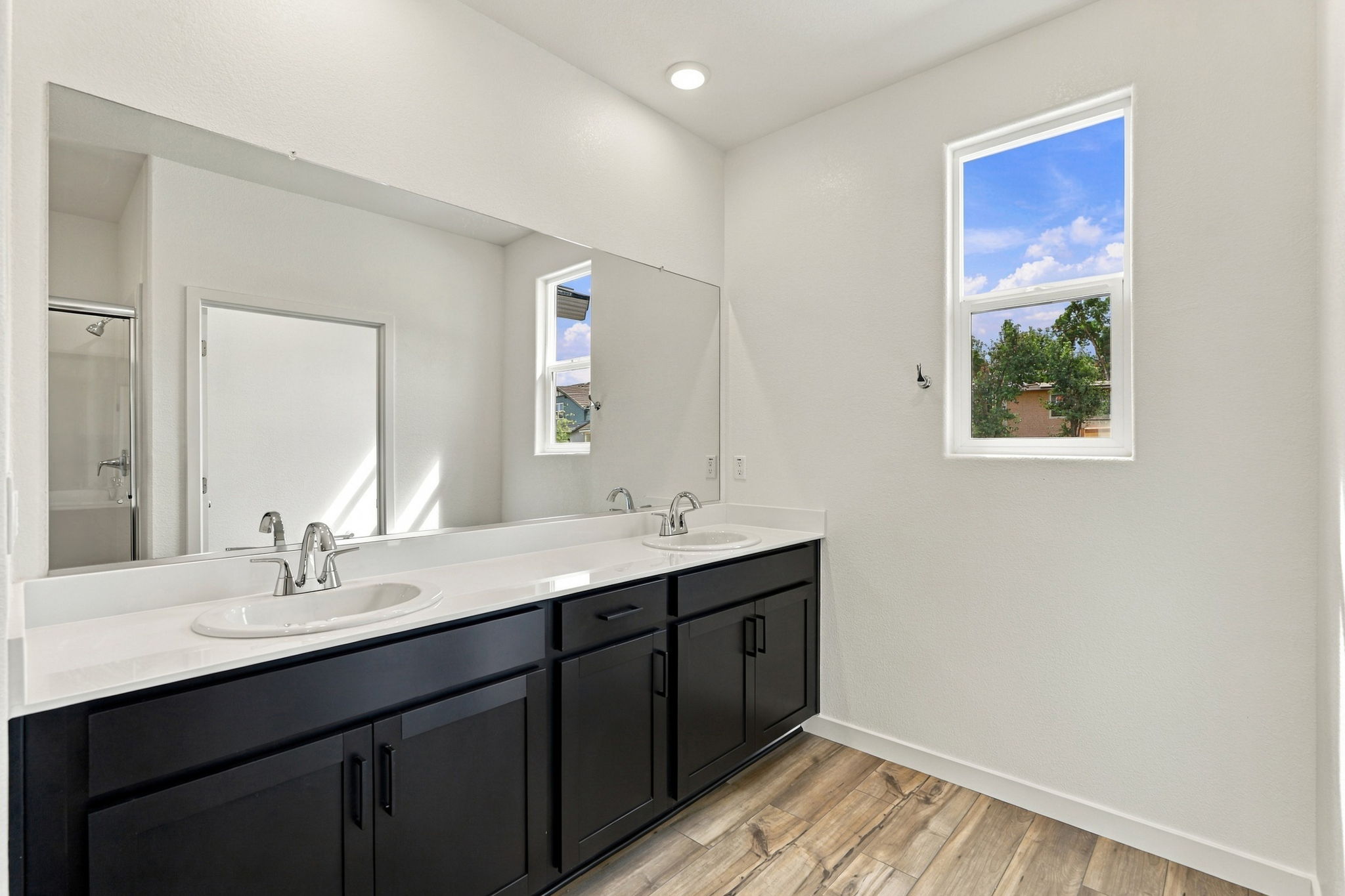 A bathroom with a large mirror.