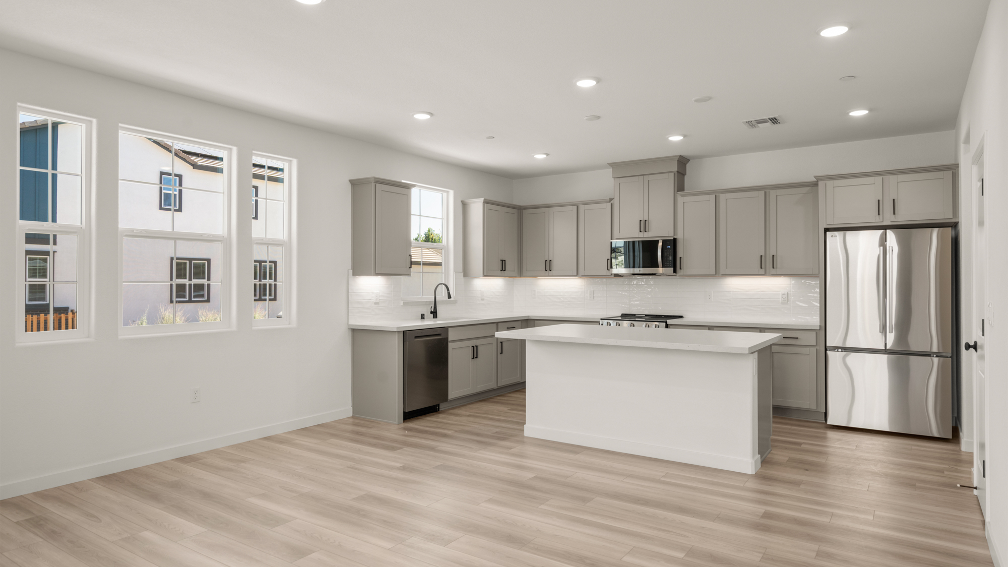 A kitchen with white cabinets.