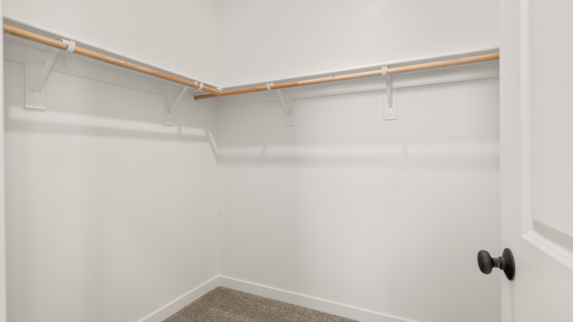 A white door with a metal bar.