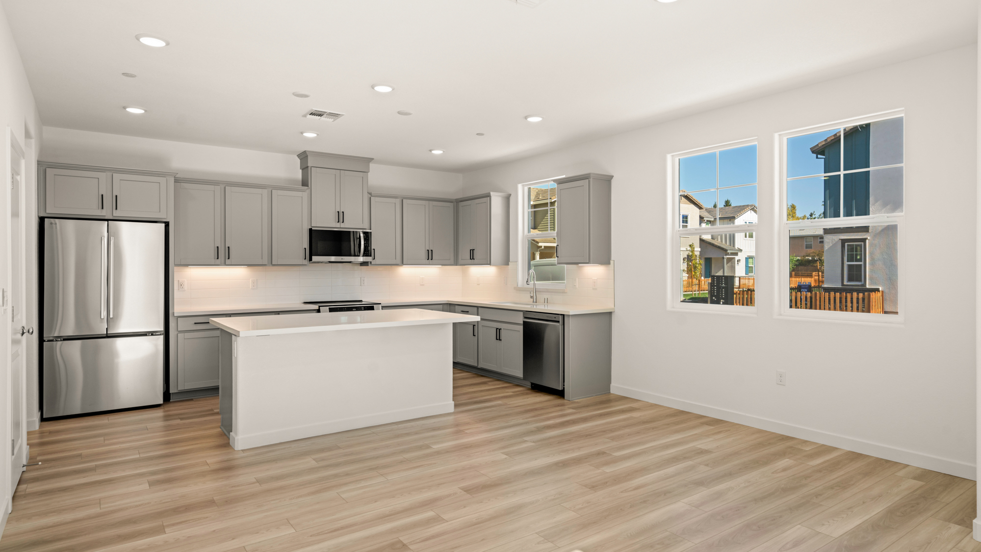 A kitchen with white cabinets.