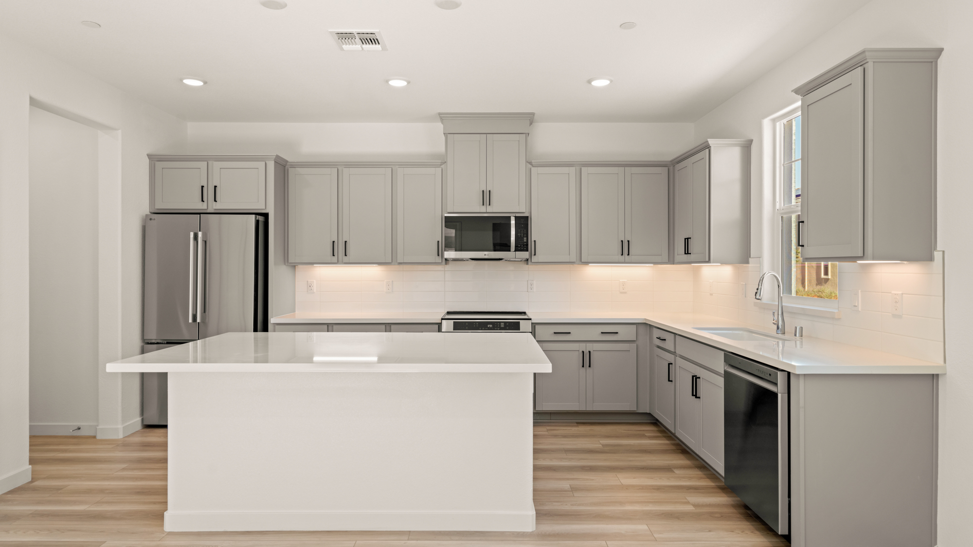 A kitchen with white cabinets.