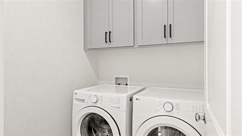 A washing machine and dryer in a room.