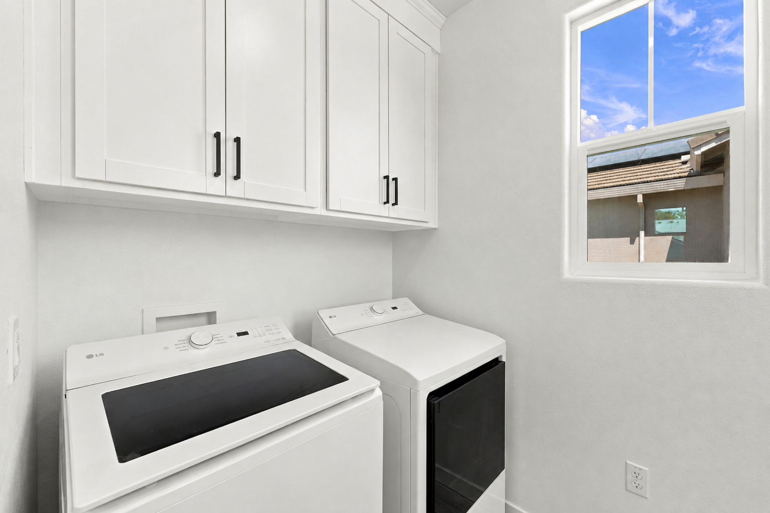 A white kitchen with white cabinets.