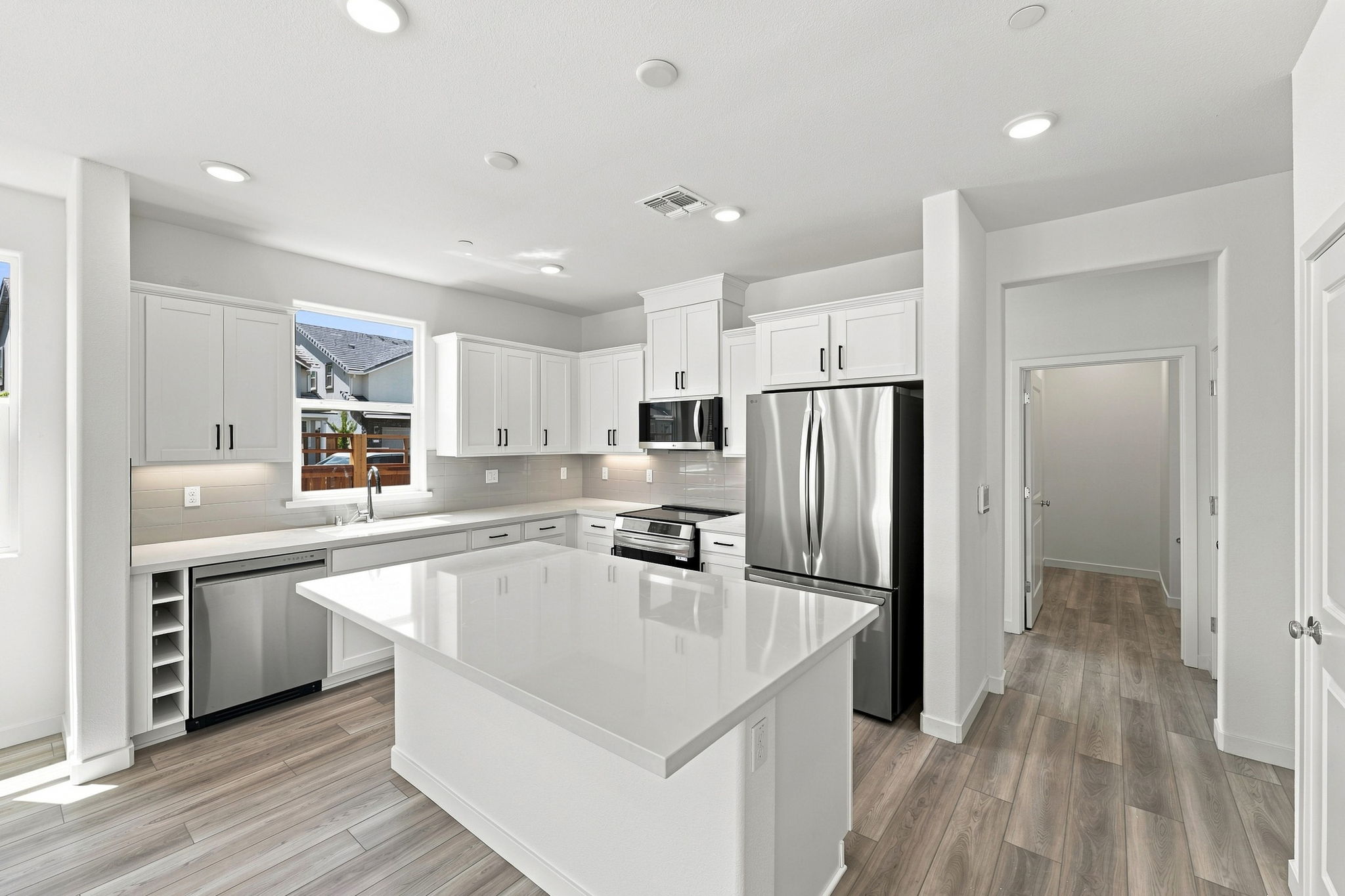 A kitchen with white cabinets.