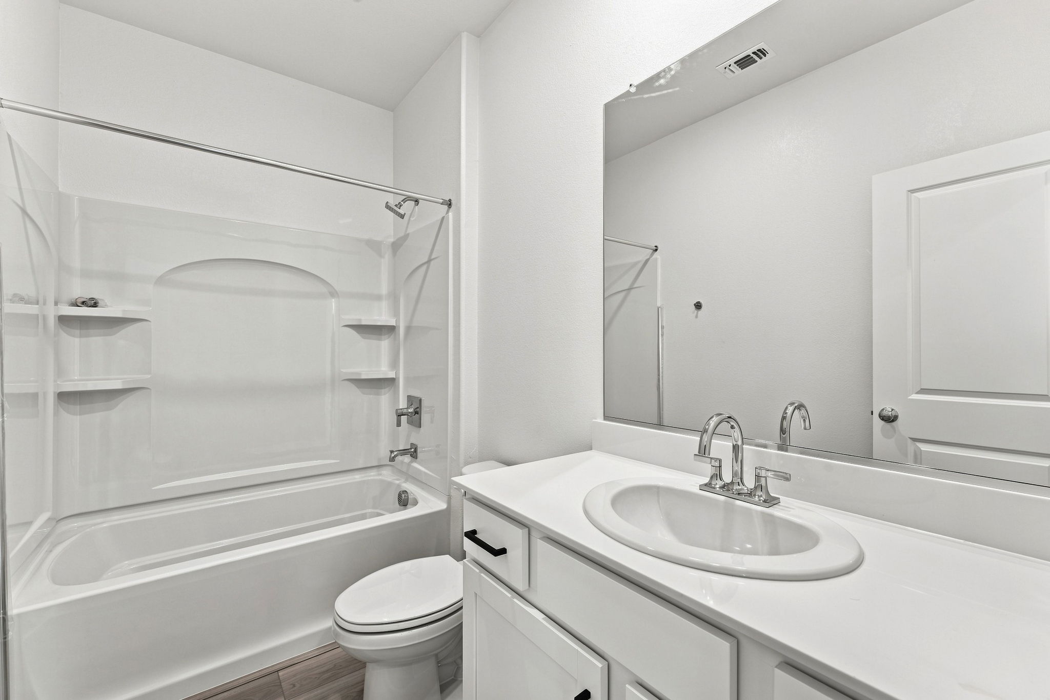 A bathroom with a sink toilet and shower.