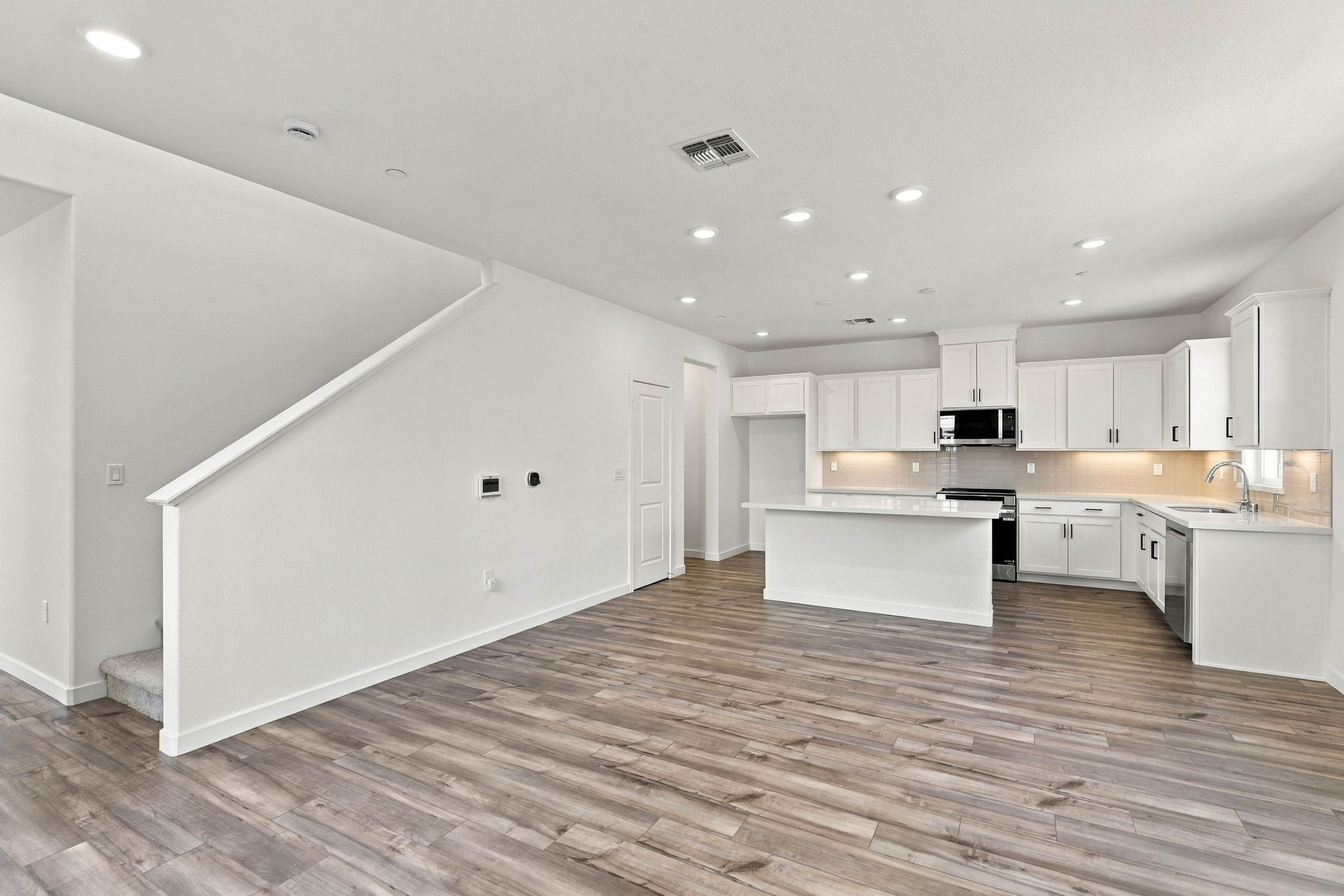 A large kitchen with white cabinets.