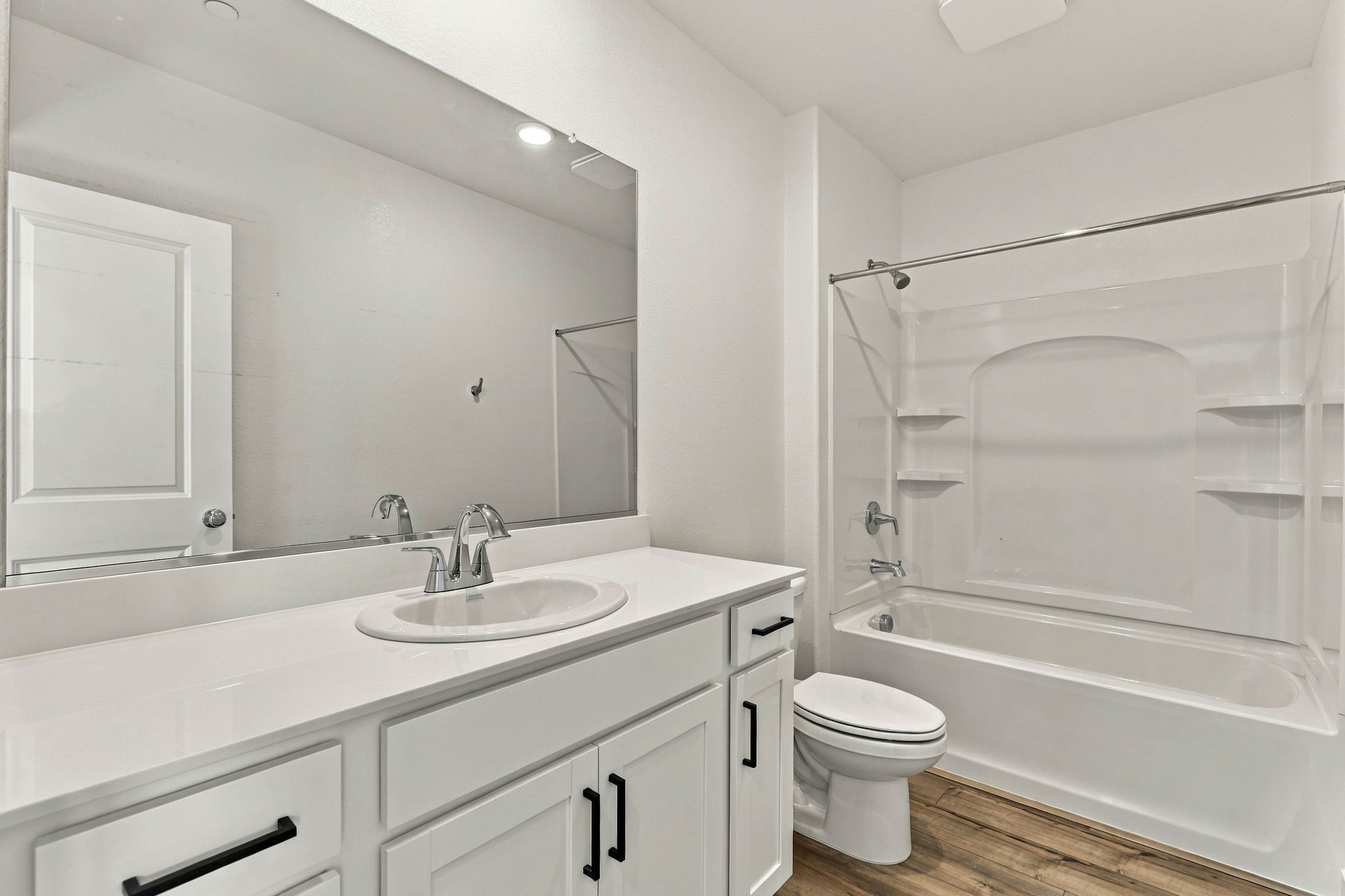 A bathroom with a tub sink and toilet.