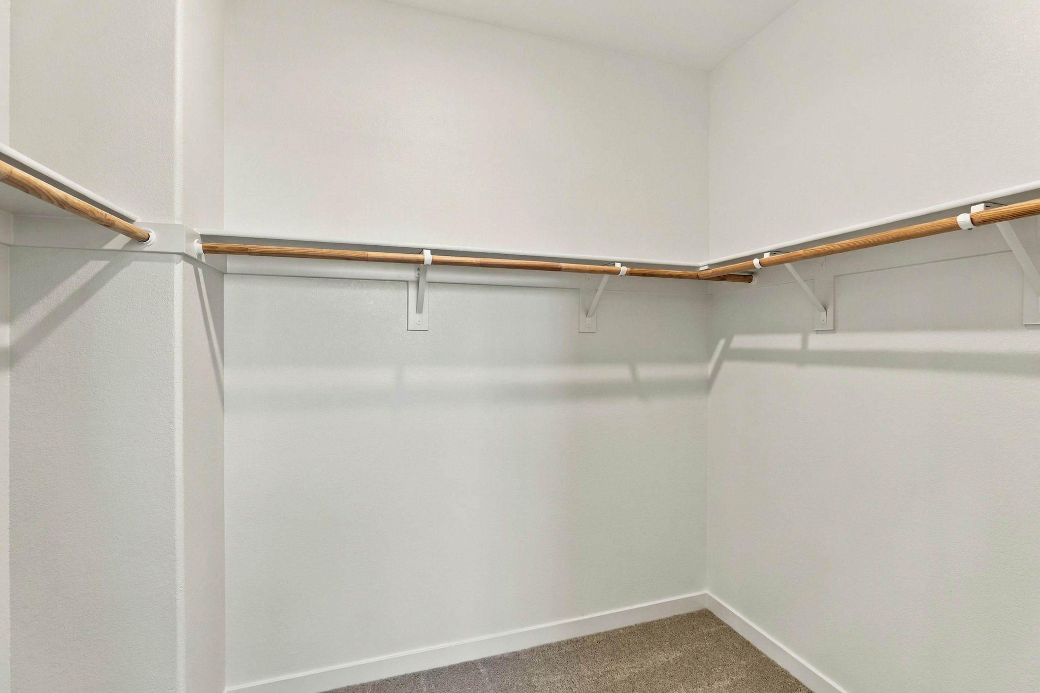 A white wall with a metal bar.