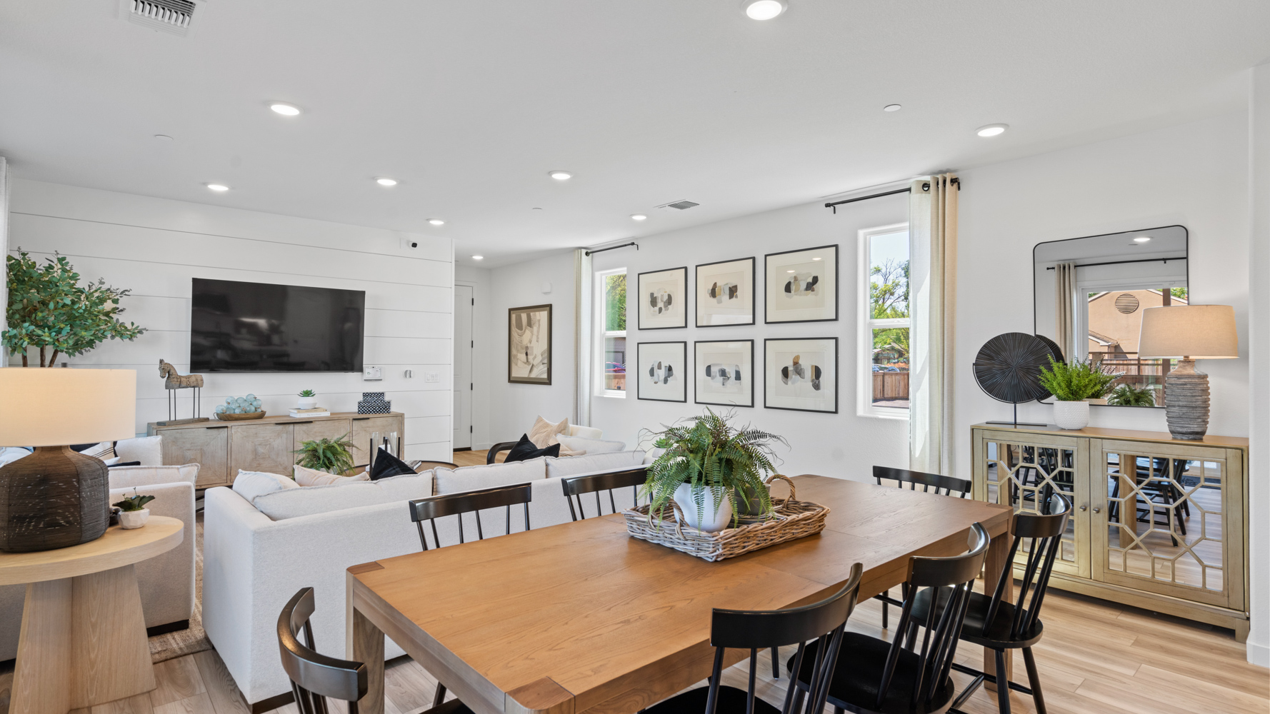 A living room with a table and chairs.