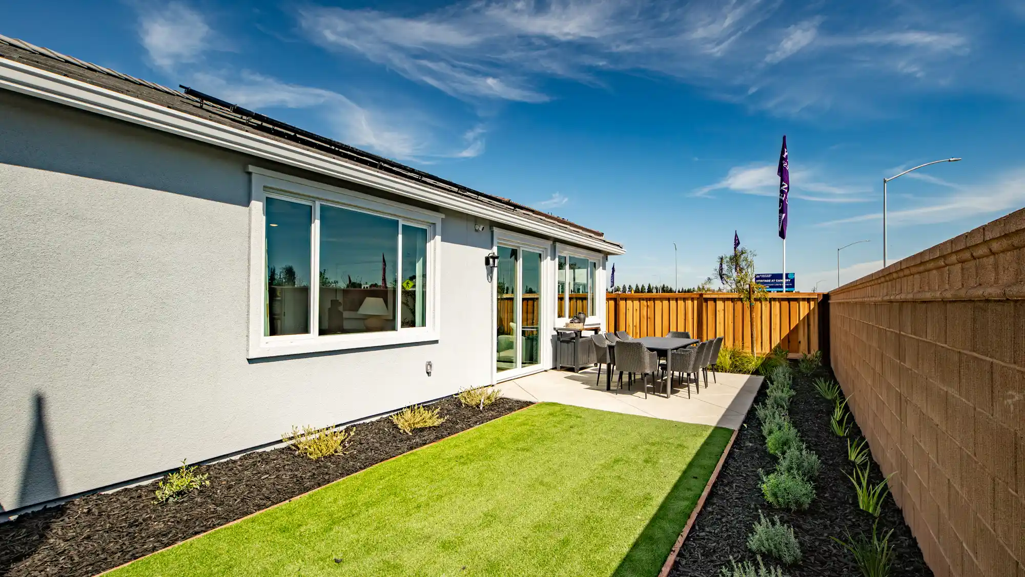 A house with a lawn and chairs.