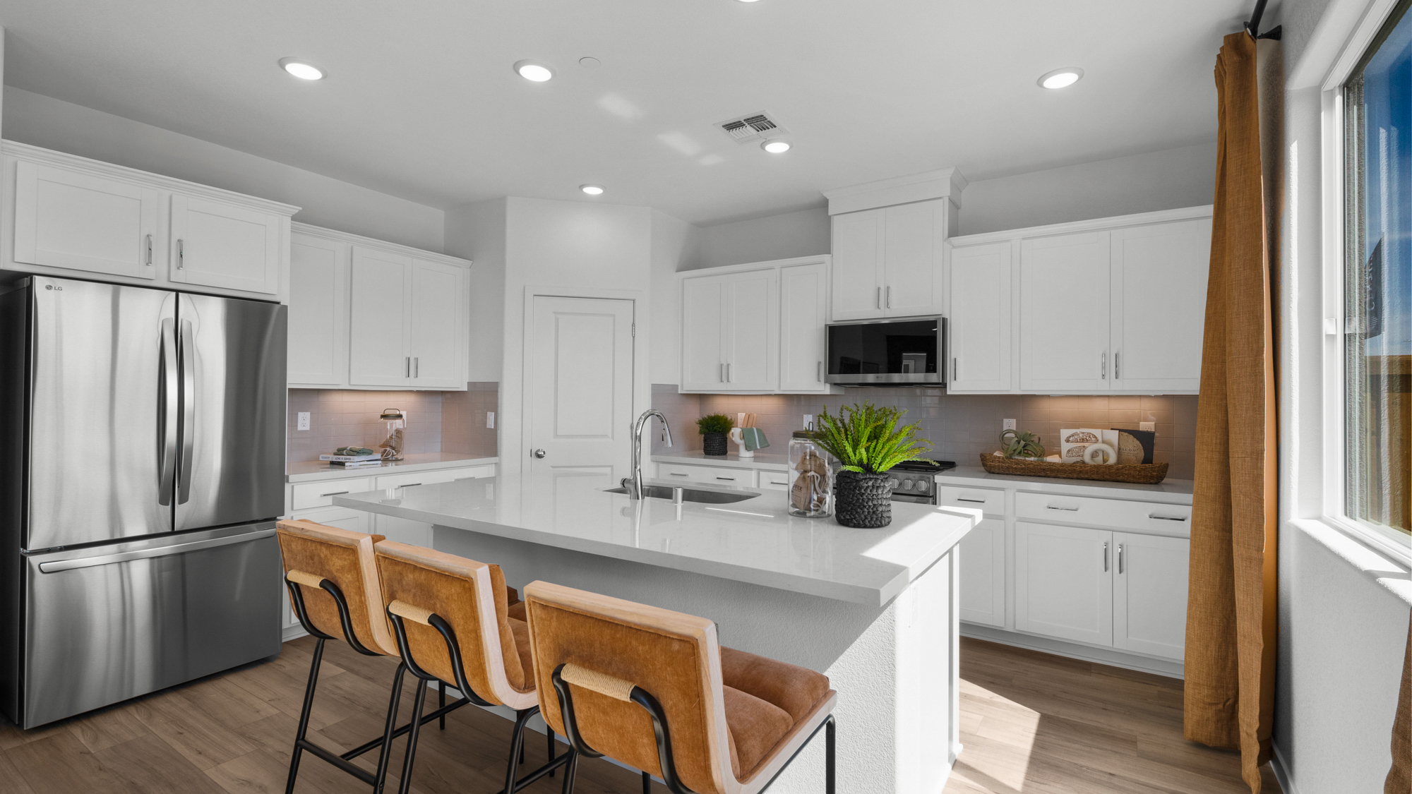 A kitchen with white cabinets.