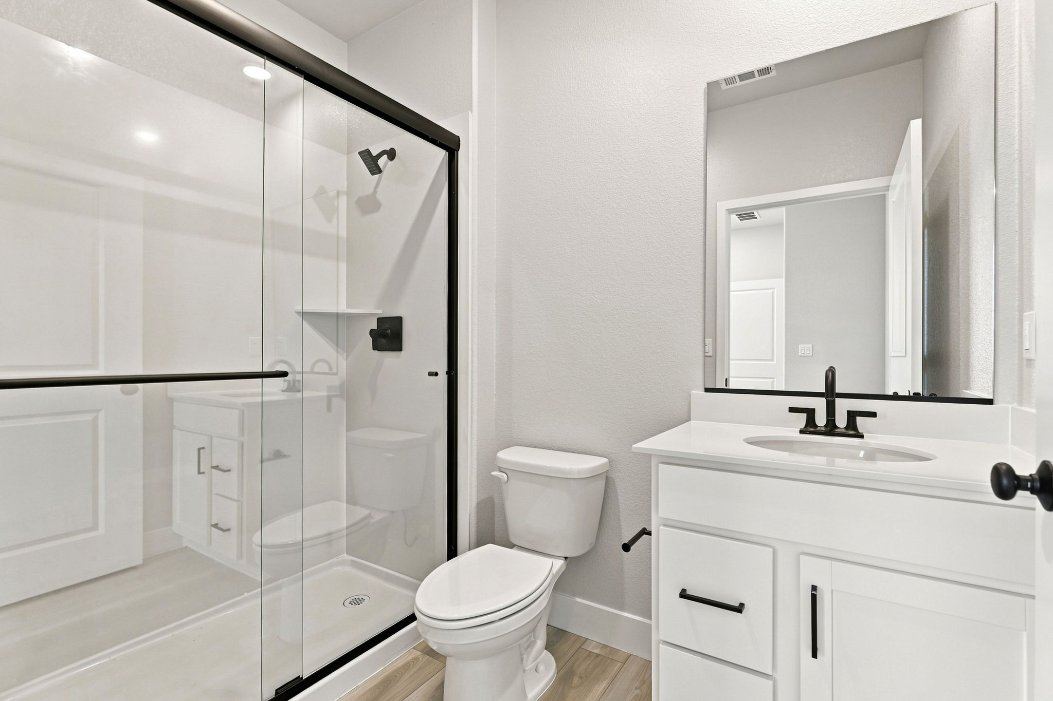 A bathroom with a glass shower.