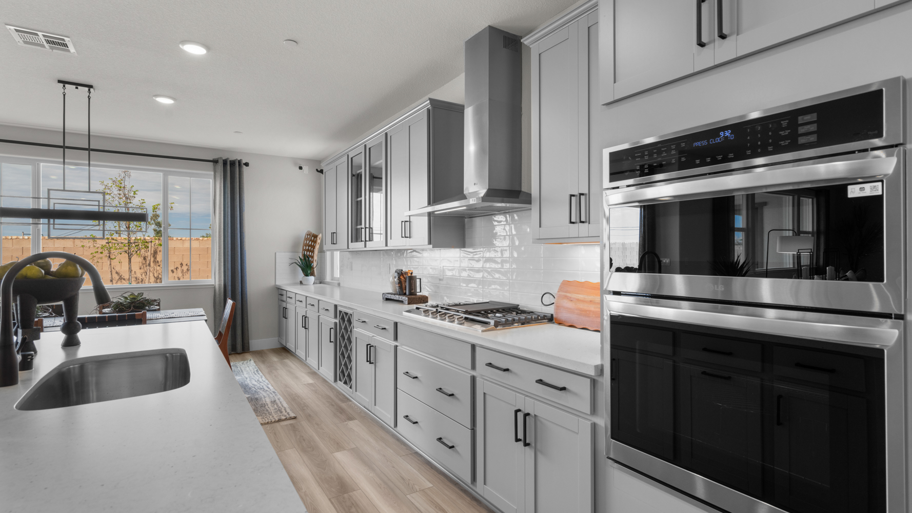 A kitchen with white cabinets.