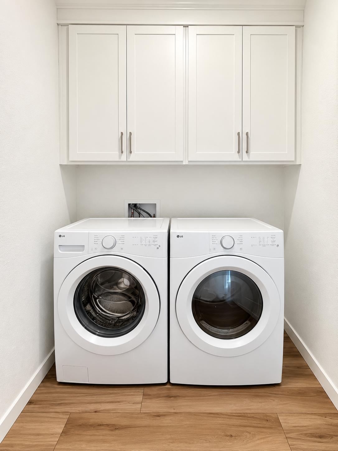 A white laundry room with a white washer and dryer.