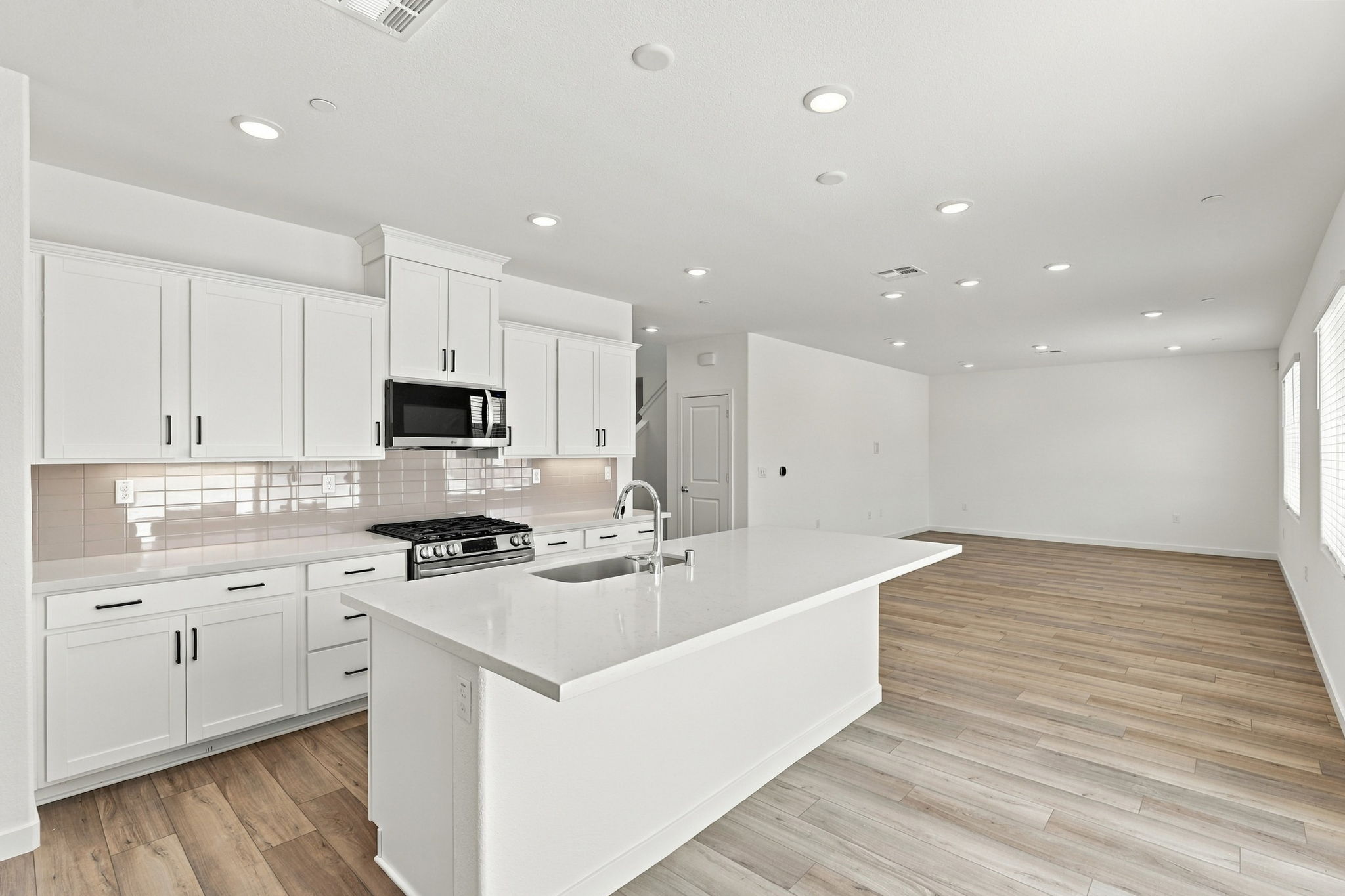 A kitchen with white cabinets.