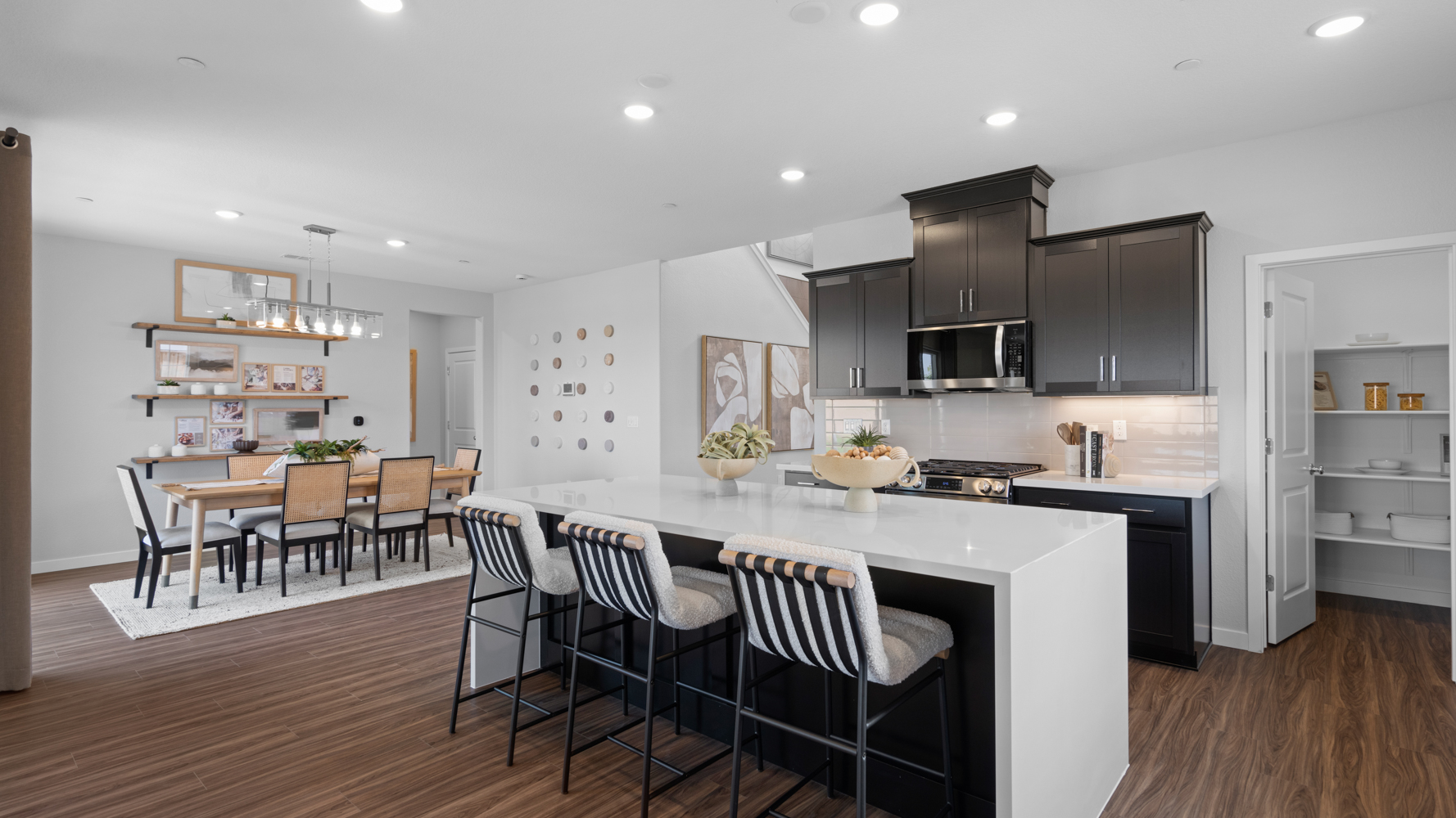 A kitchen with a dining table and chairs.